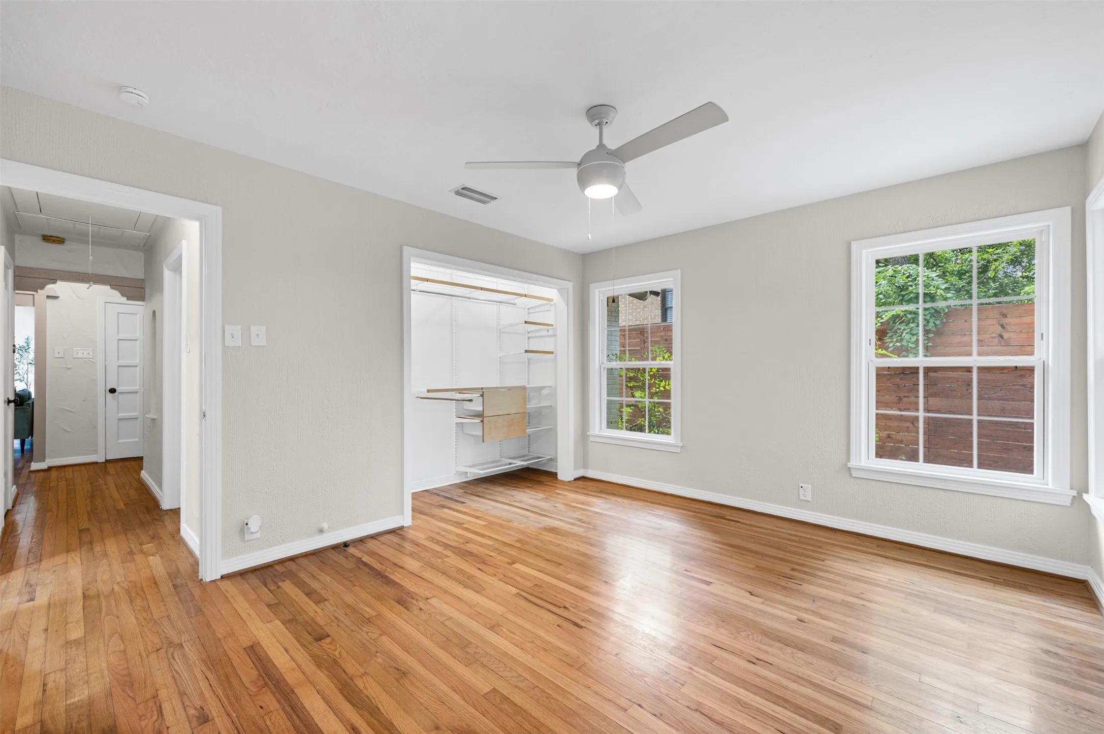 Bedroom with original hardwoods and closet built-ins