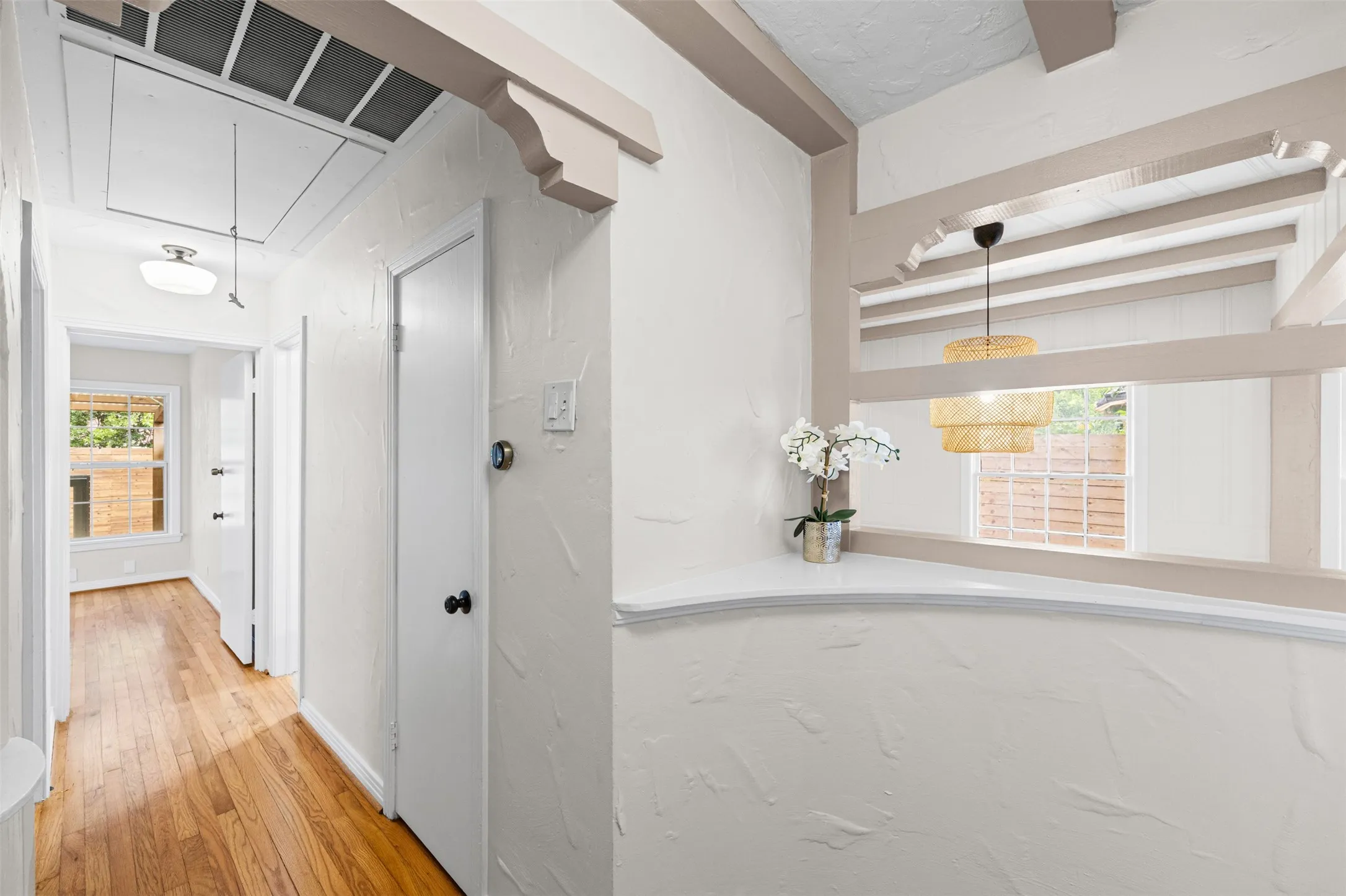 Entryway with decor ledges overlooking dining area