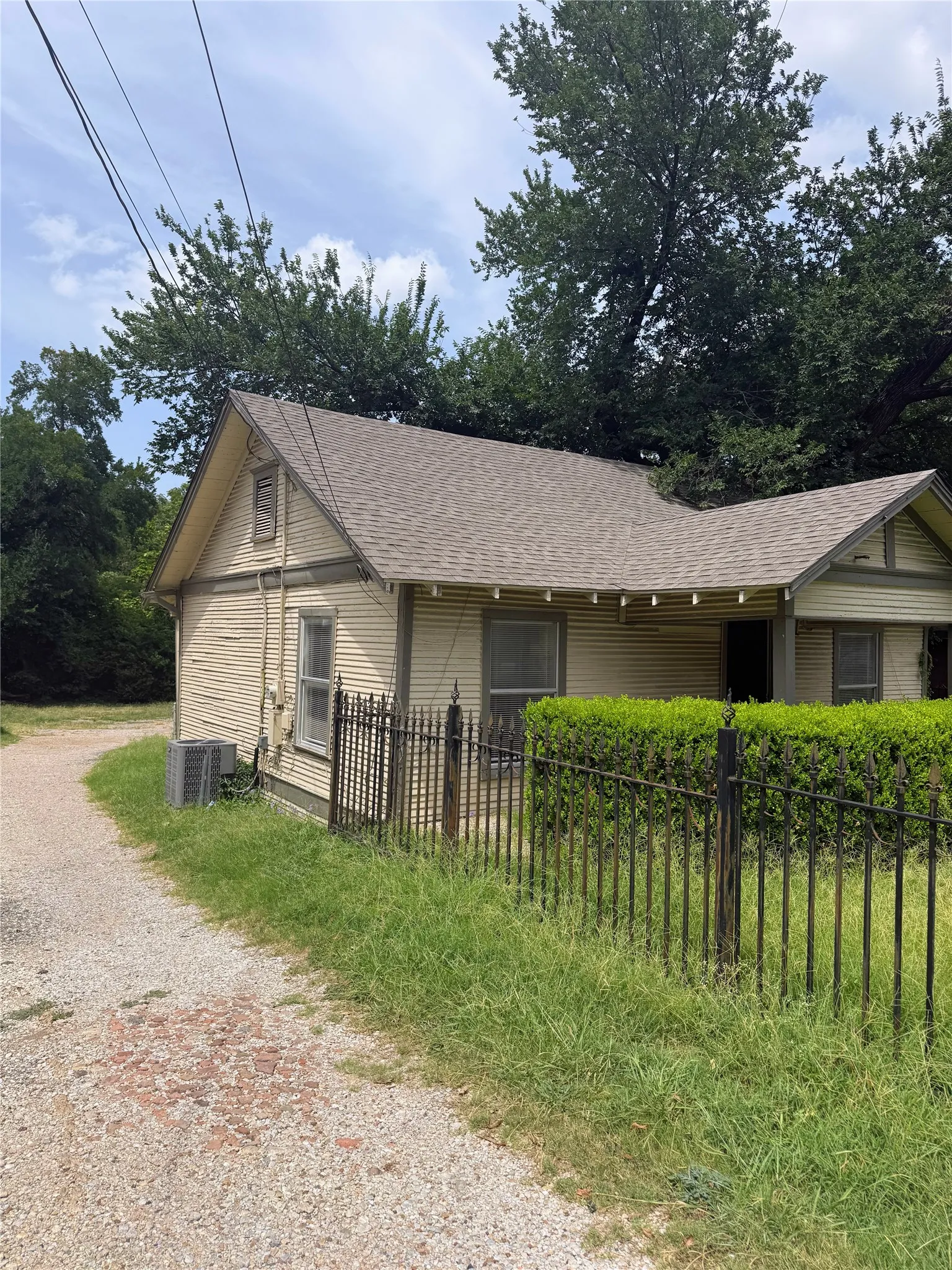 Exterior siding with a gabled roofline and an exposed vent