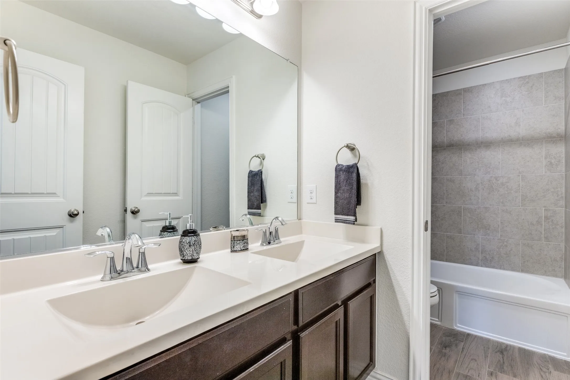 Full bathroom featuring vanity, hardwood / wood-style floors, toilet, and tub / shower combination