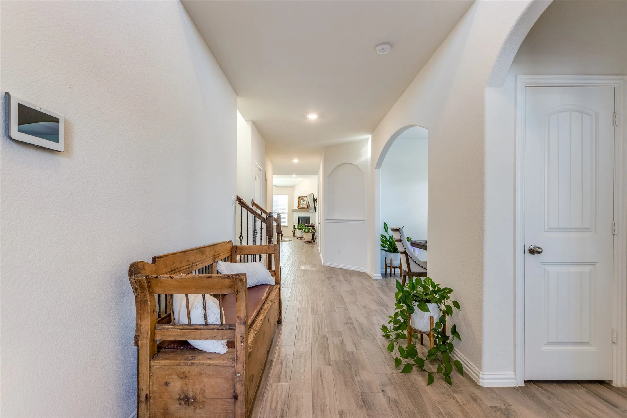 Hall with light hardwood / wood-style floors