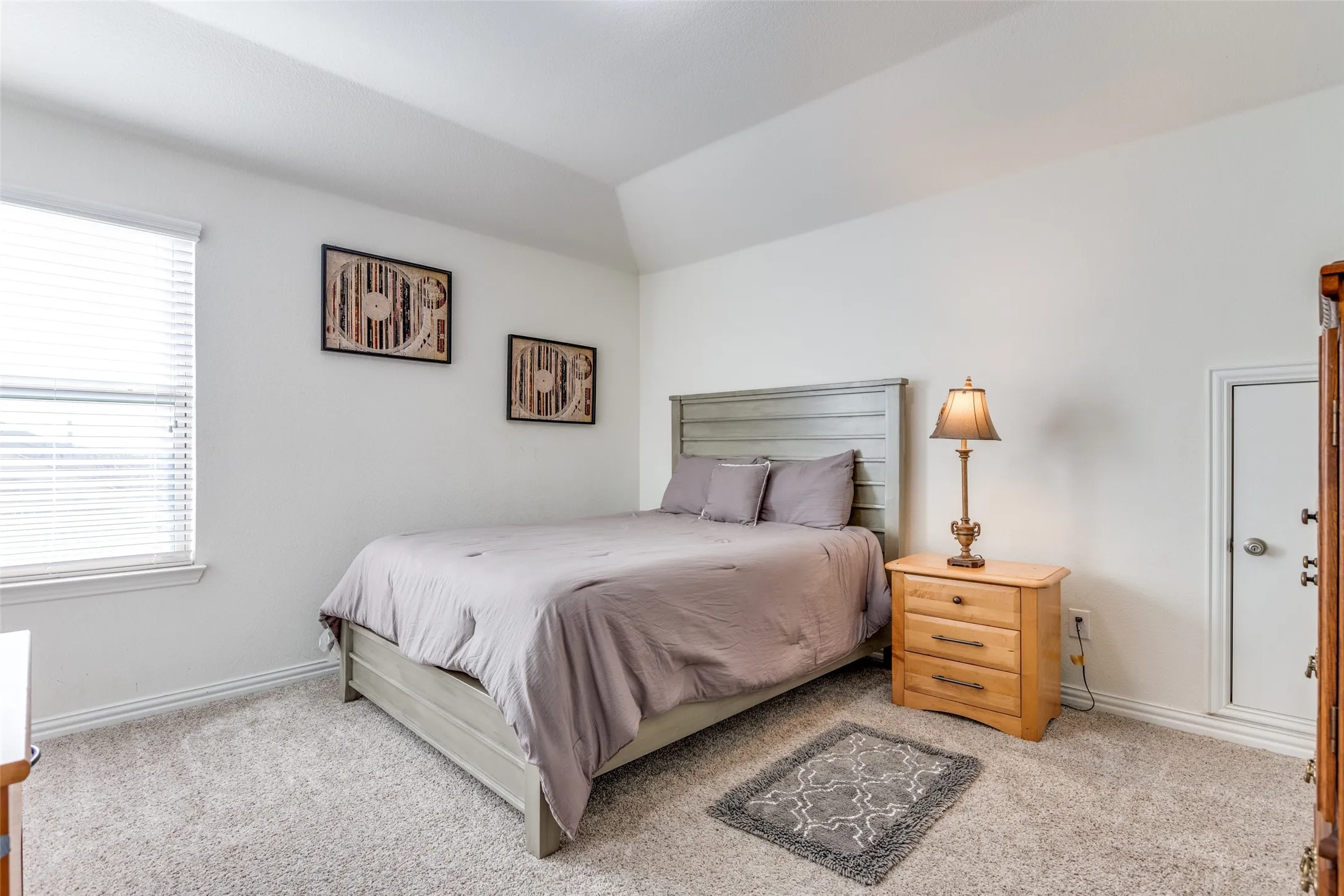Carpeted bedroom with lofted ceiling