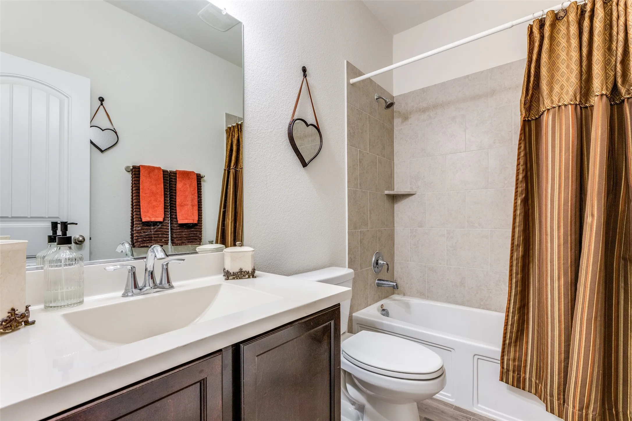 Full bathroom with shower / bath combo with shower curtain, toilet, and vanity