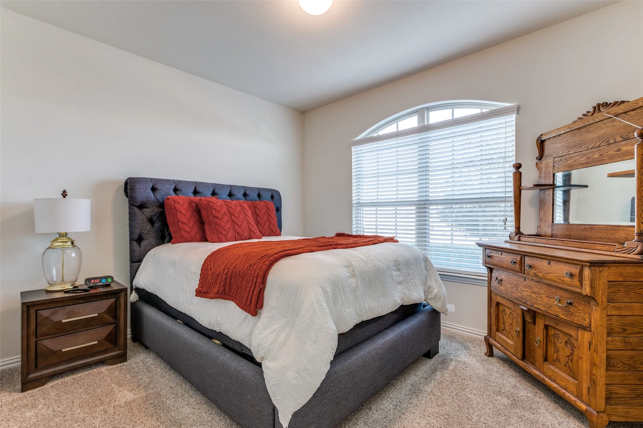 Bedroom with light colored carpet