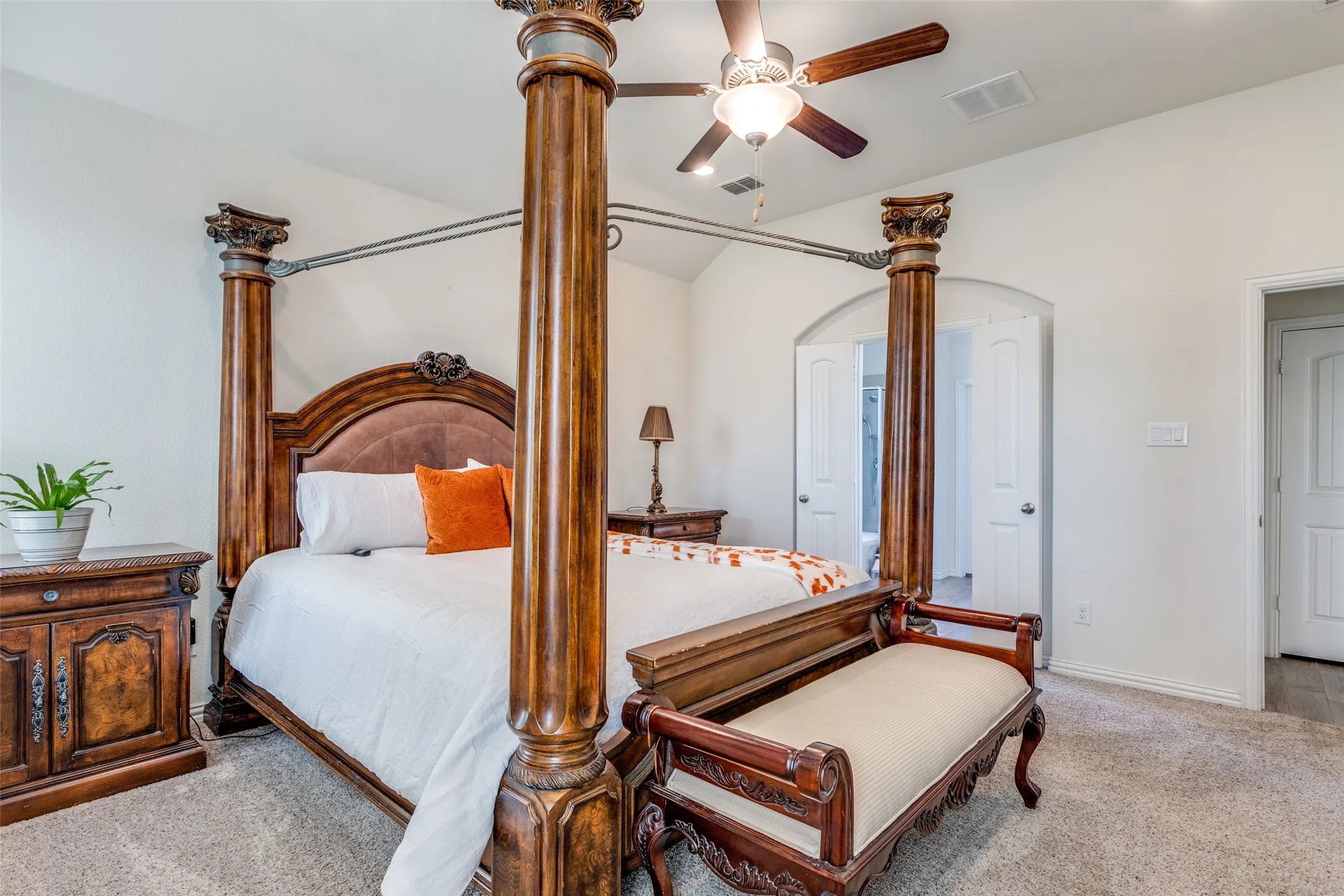 Bedroom featuring ceiling fan, lofted ceiling, and light colored carpet