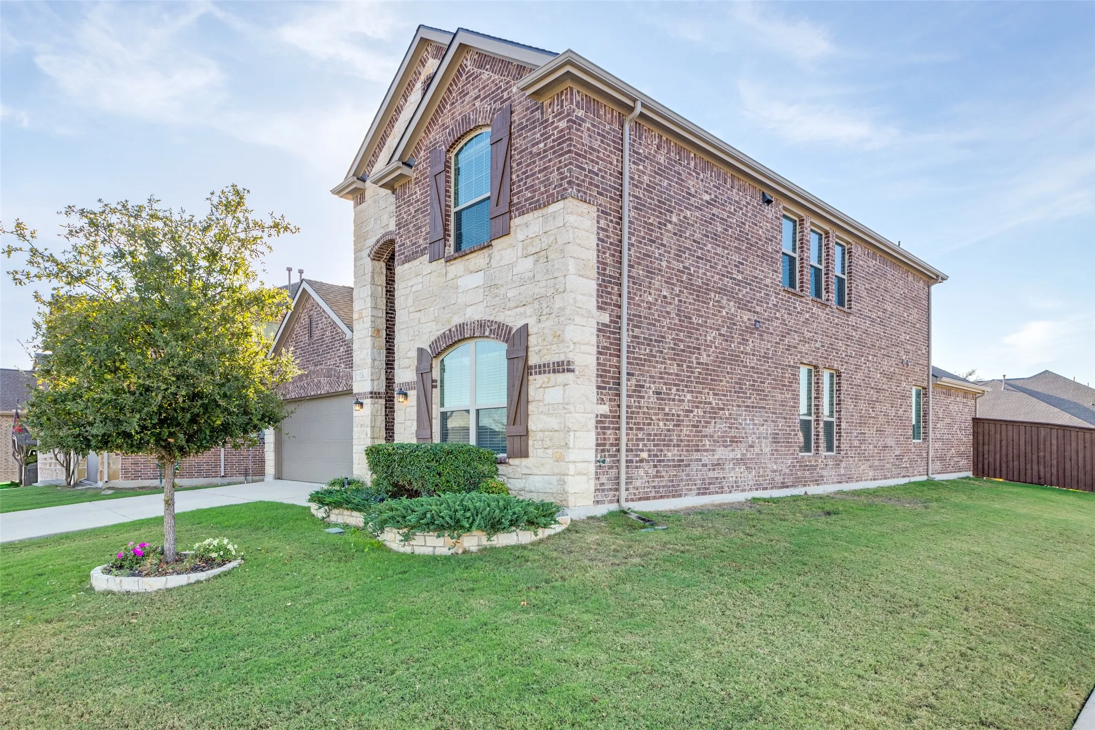View of side of property with a lawn and a garage