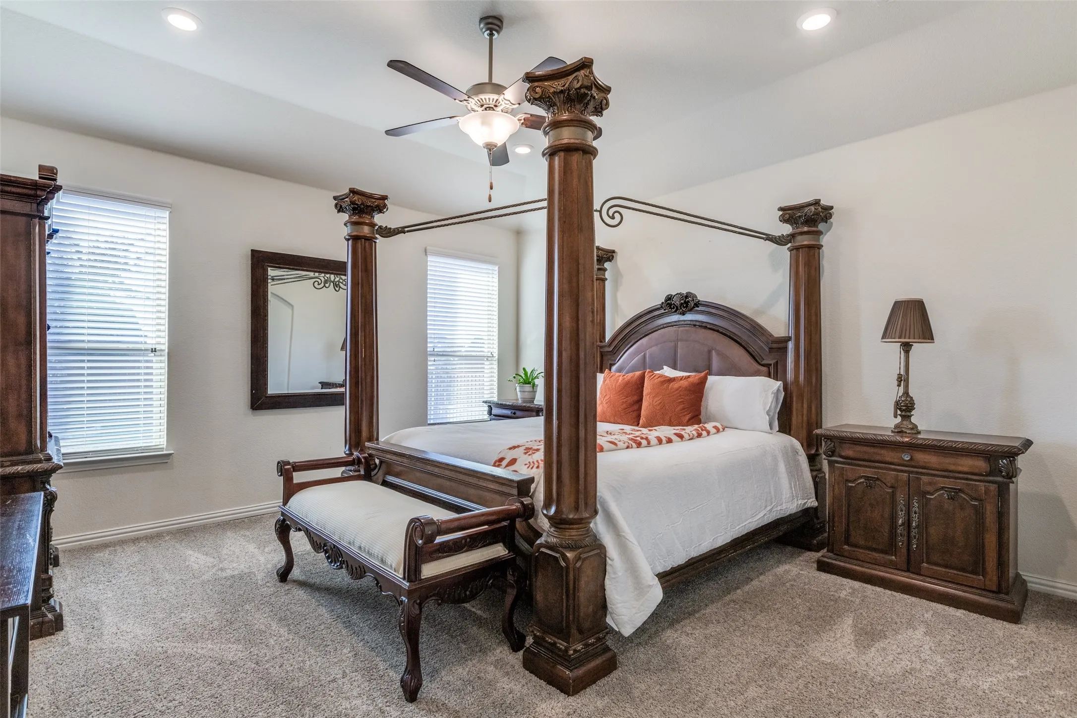 Carpeted bedroom featuring ceiling fan
