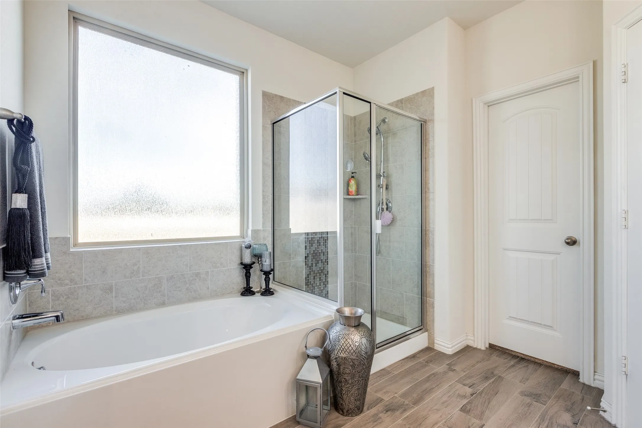 Bathroom featuring independent shower and bath and hardwood / wood-style floors