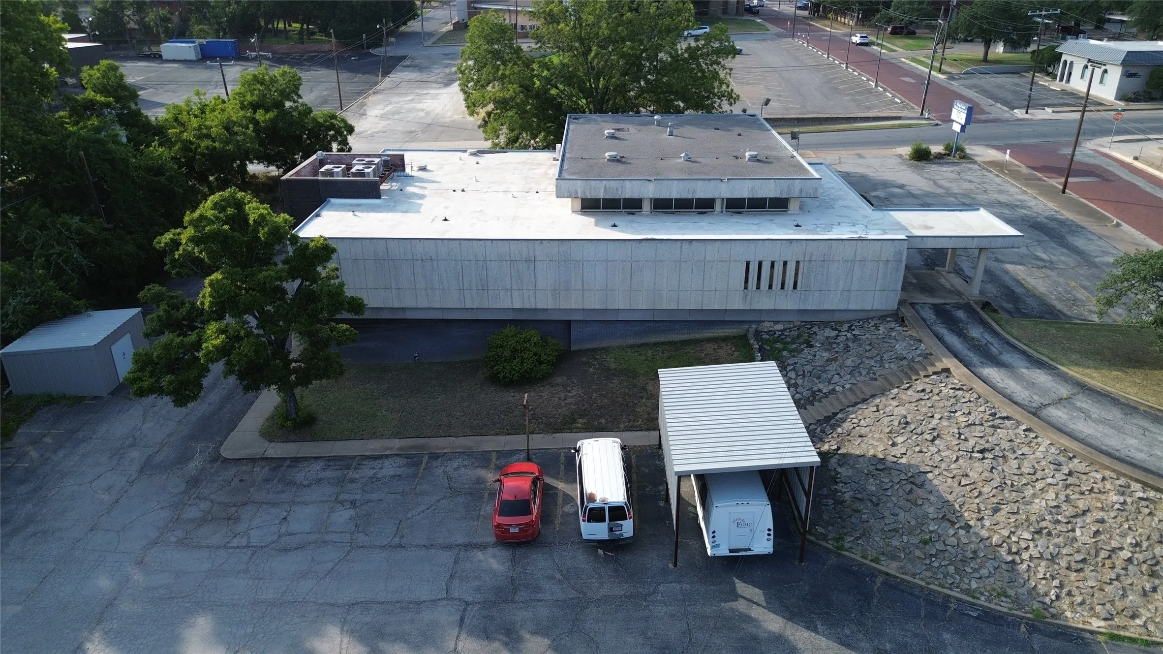 Commercial building with a flat roof, concrete exterior, and multiple windows