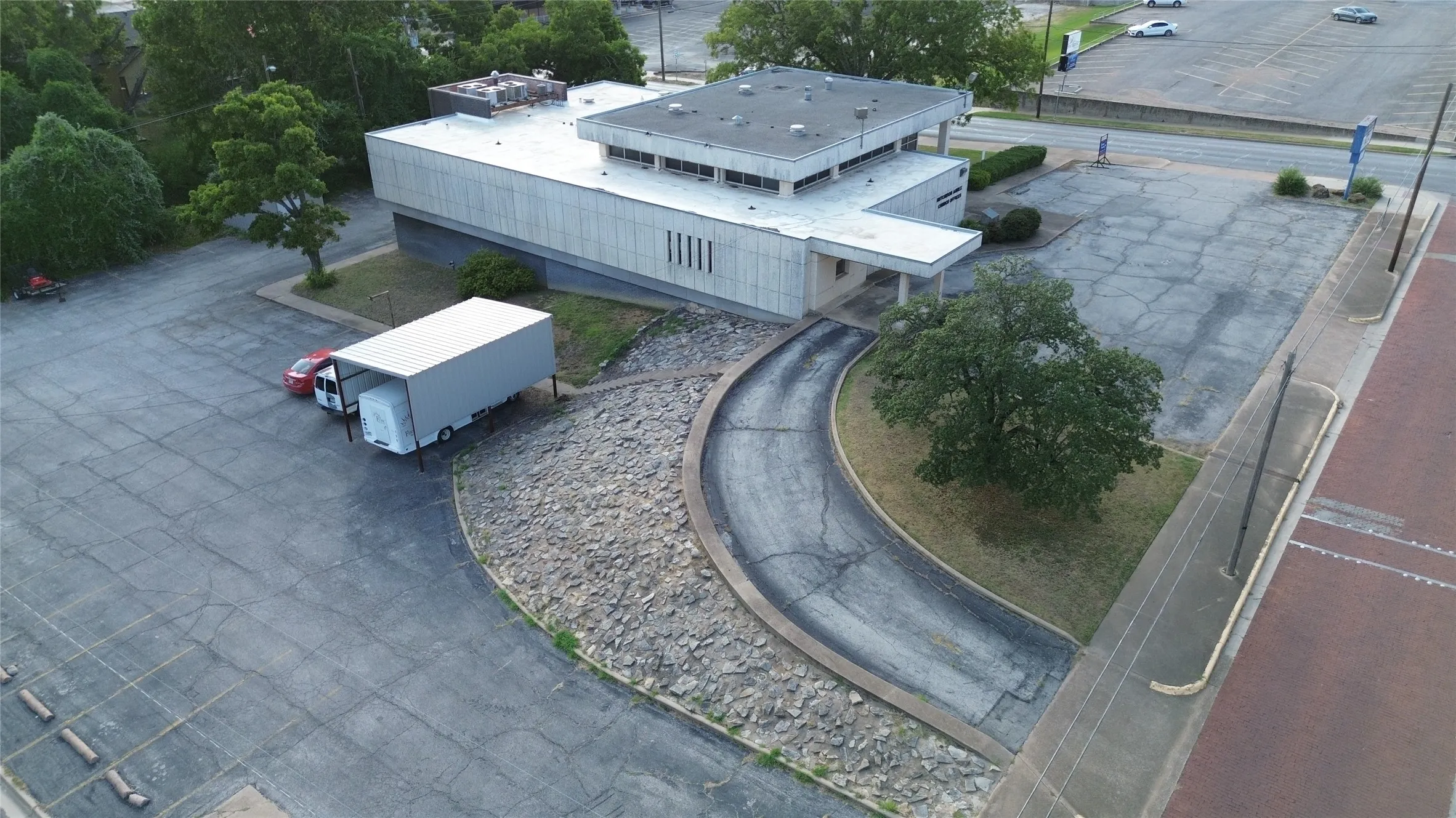Commercial building featuring a flat roof and a light-colored facade