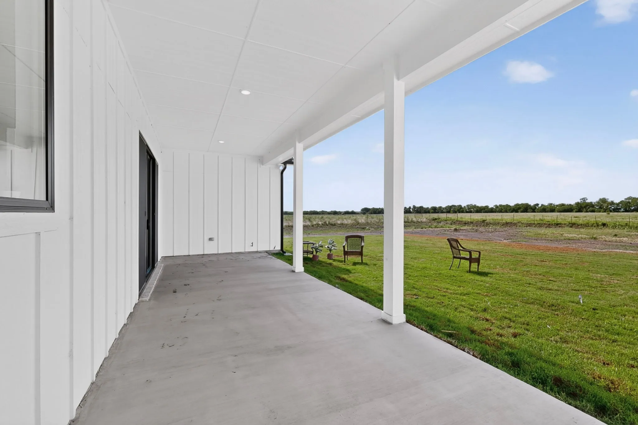 Covered outdoor patio with a concrete surface