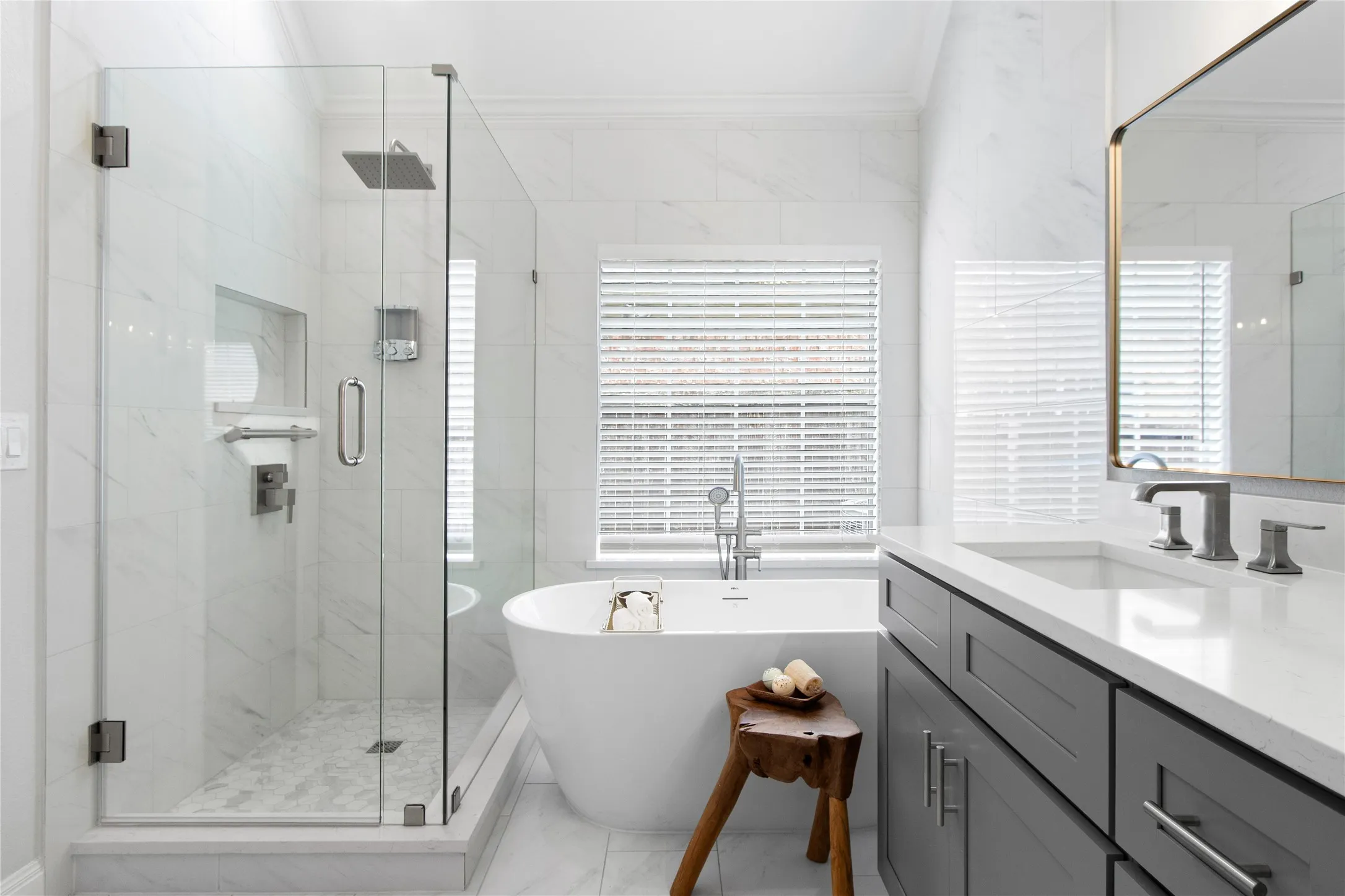 Walk-in shower with clear glass enclosure and rainfall showerhead