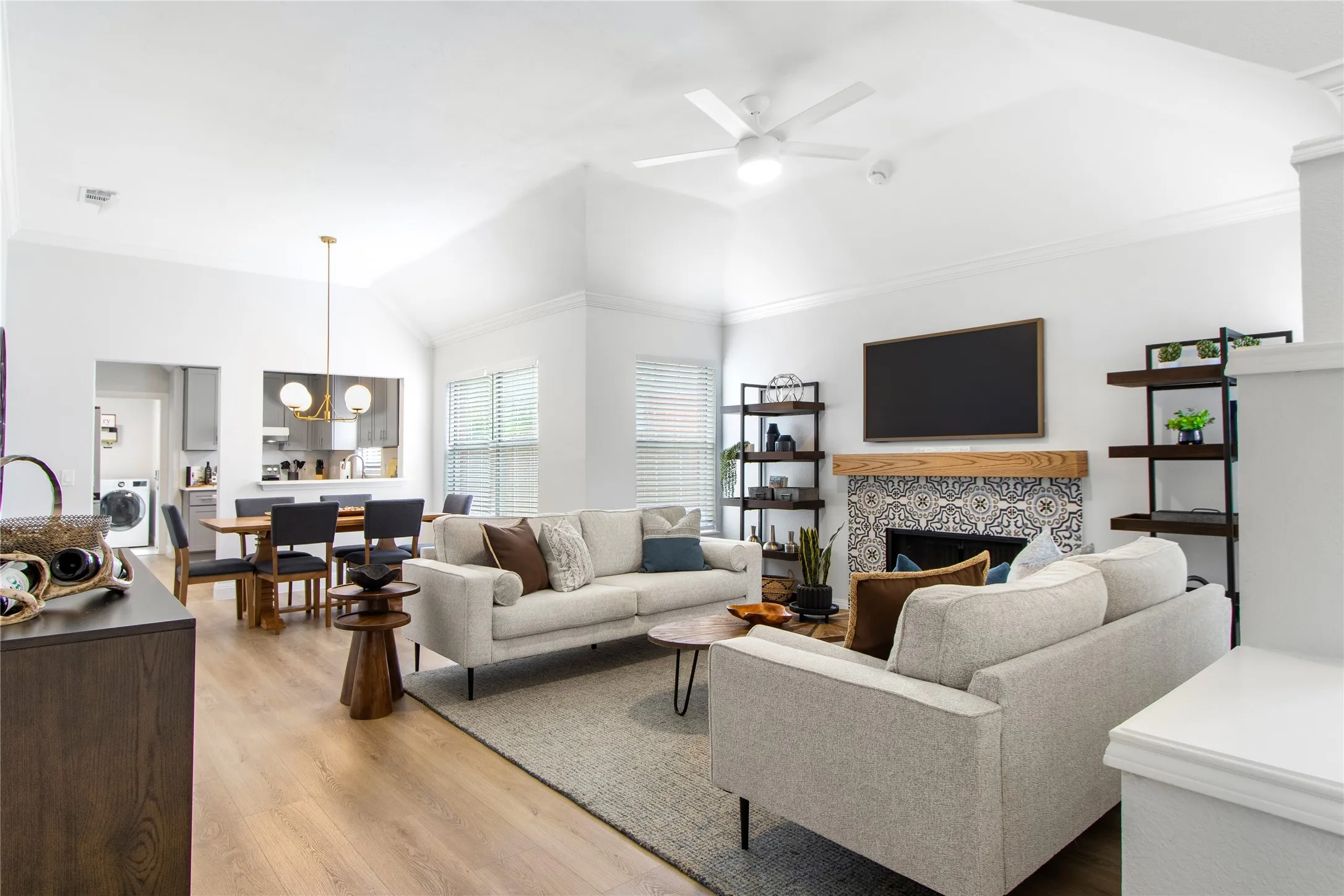 Vaulted ceilings highlight the bright living area with wood-finish flooring