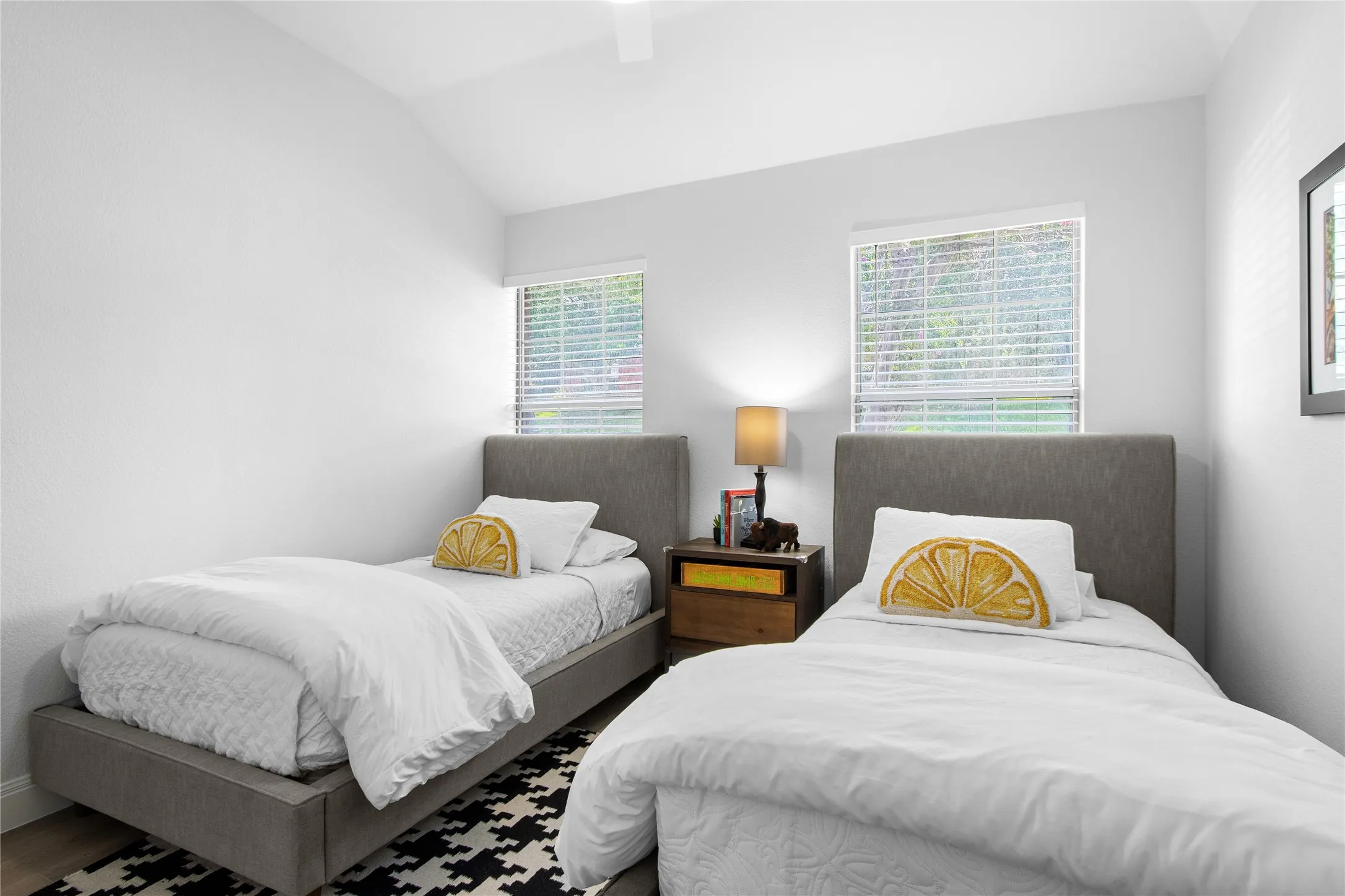 Vaulted ceilings complement two windows with blinds