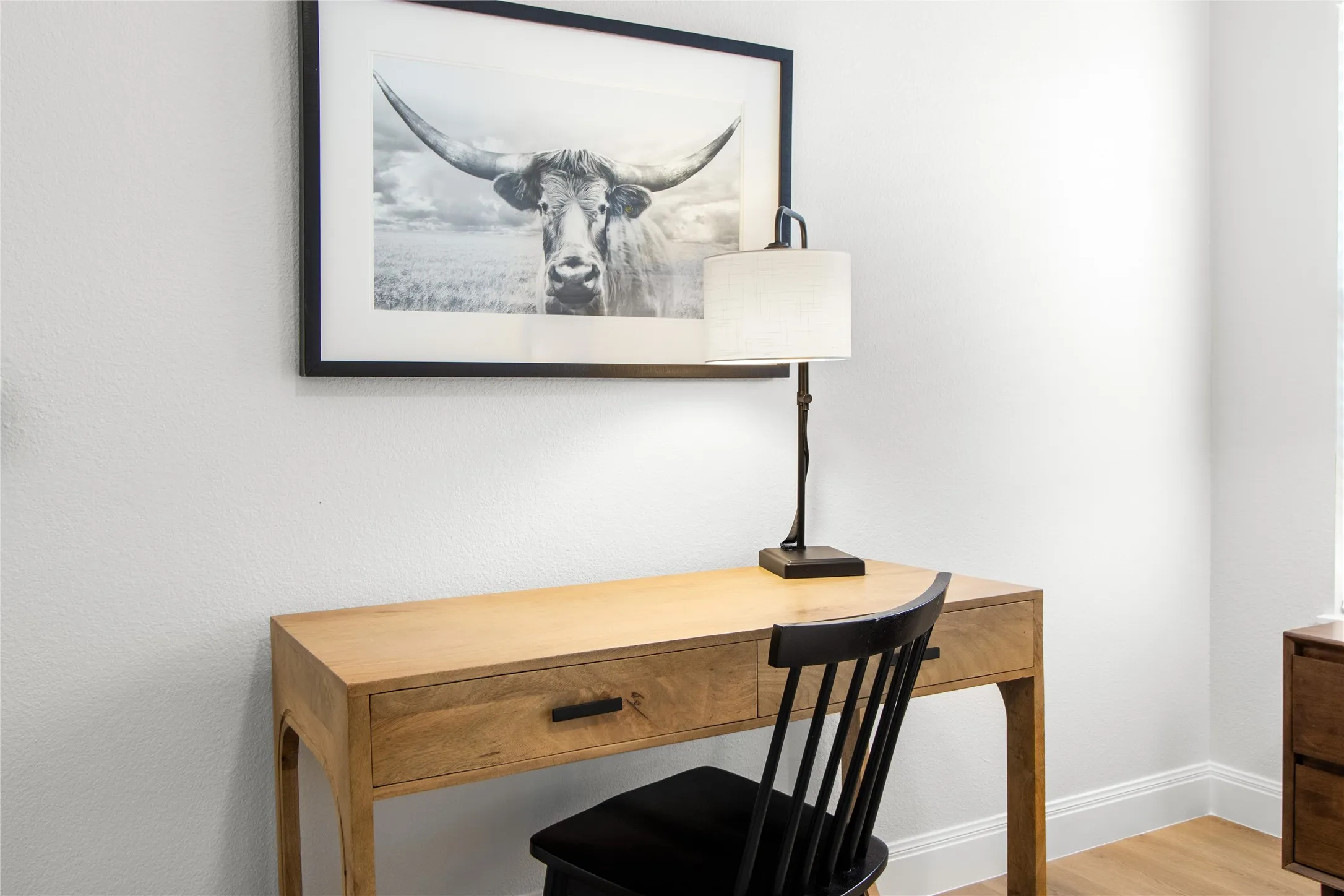 Natural wood-finish desk with a single drawer and dark hardware