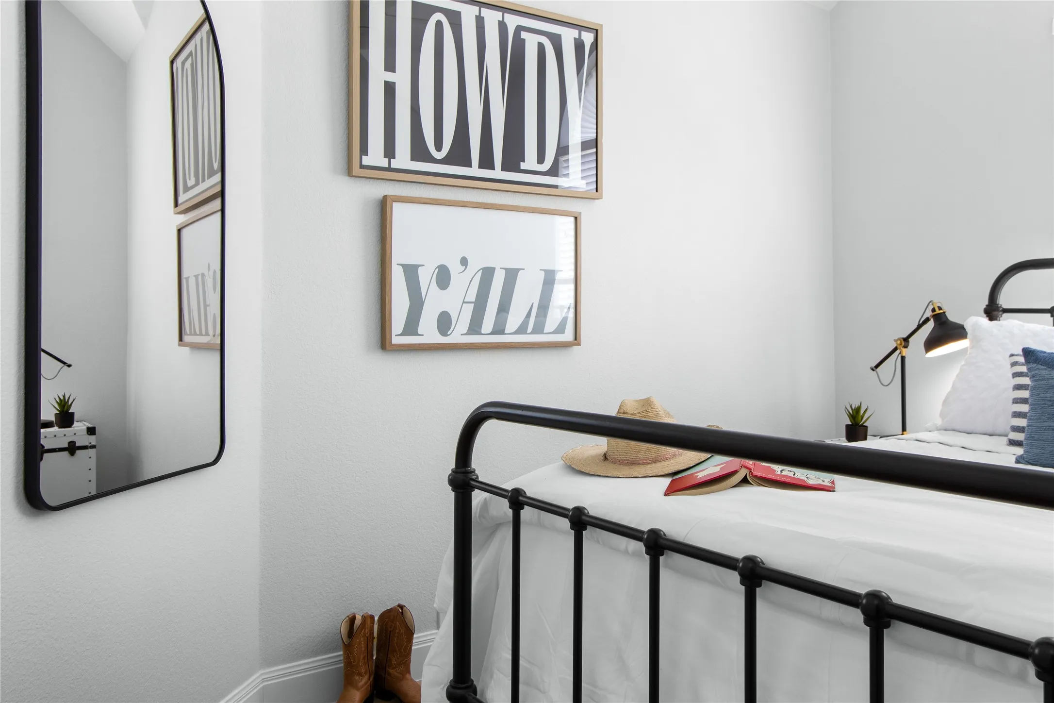 Bedroom featuring a black metal bed frame with decorative finials