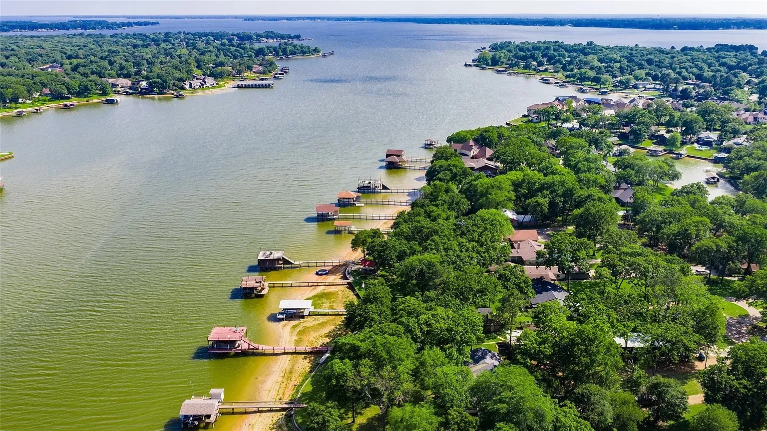 Expansive waterfront properties featuring private docks and mature tree coverage