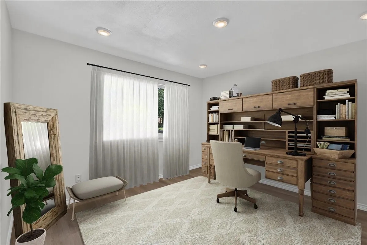Recessed ceiling lighting illuminates a spacious room featuring light wood-finish flooring and a large window with sheer white curtains