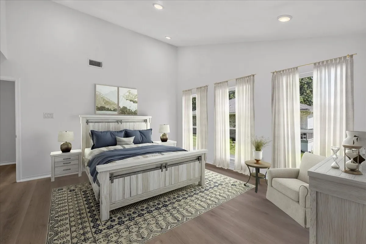 Spacious room featuring vaulted ceilings, recessed lighting, and wood-finish flooring