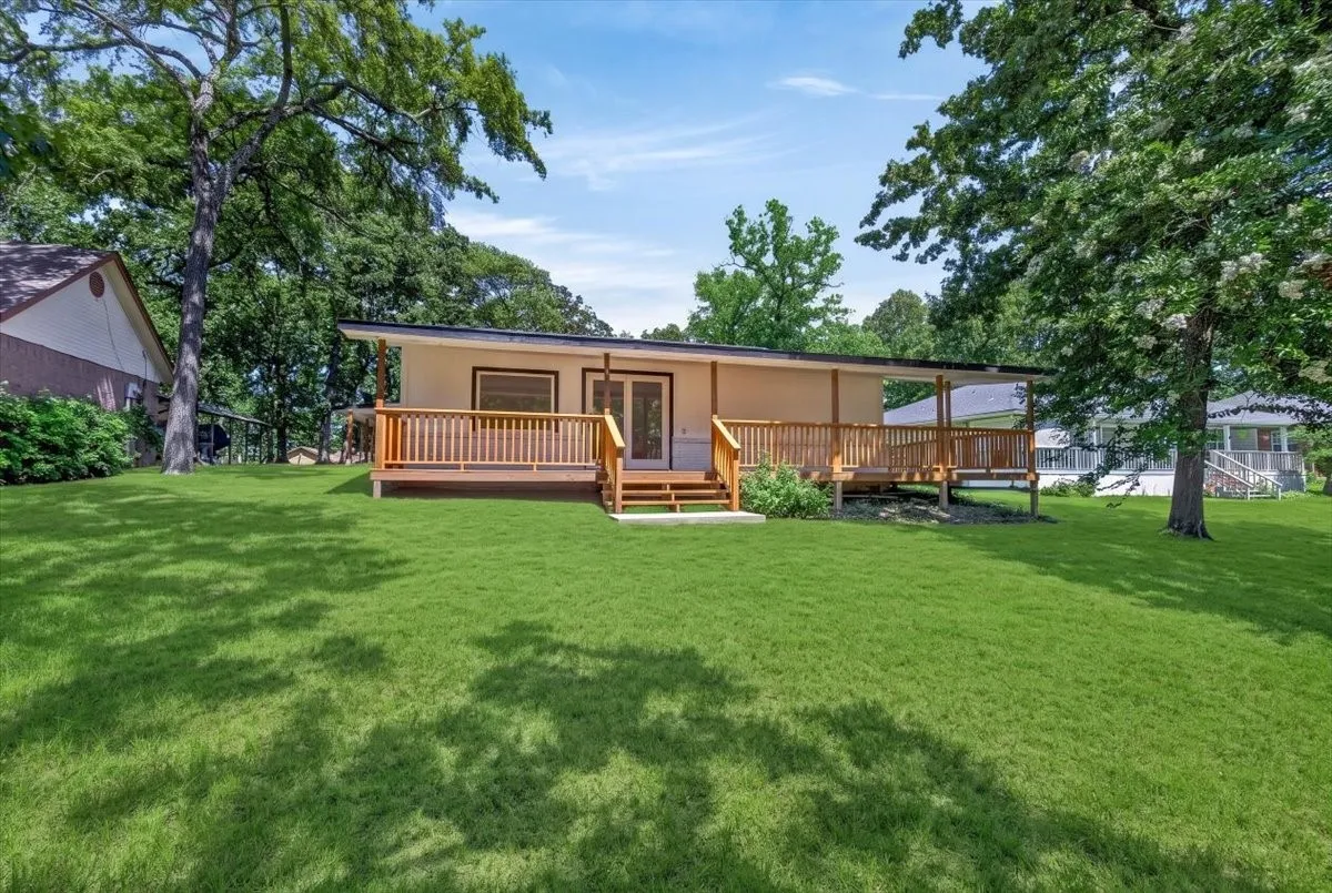 Expansive green lawn providing a backdrop to a raised rear deck