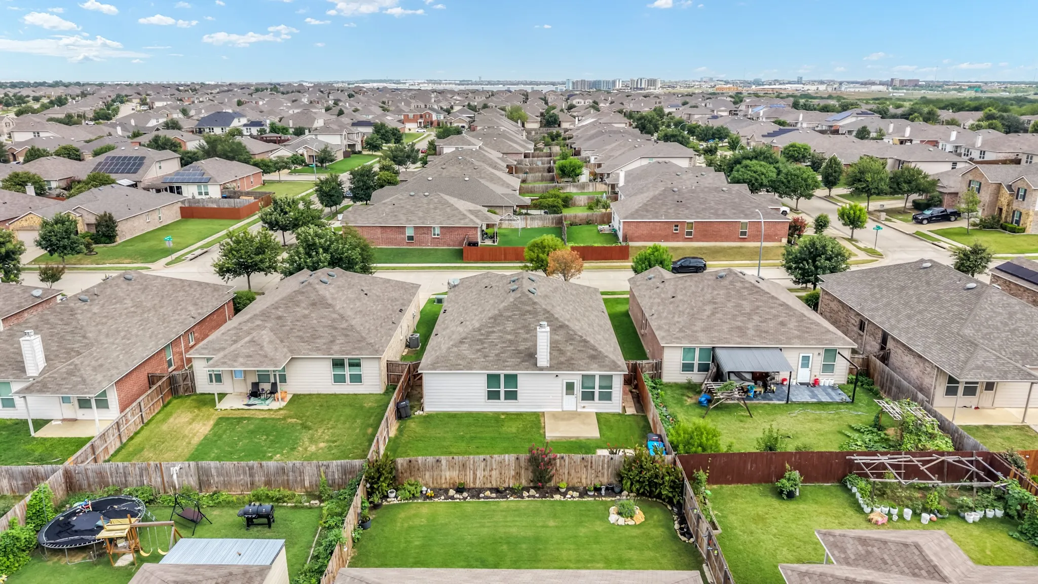 Aerial perspective of a residential neighborhood featuring single-story homes with shingle roofs