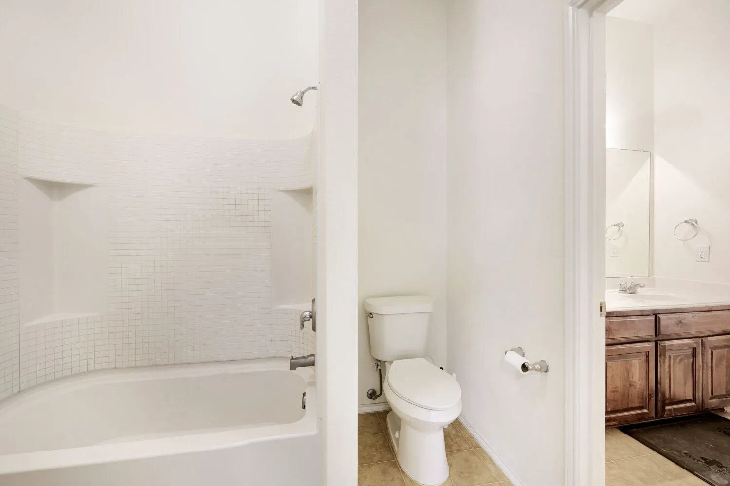 White tiled shower and tub combination