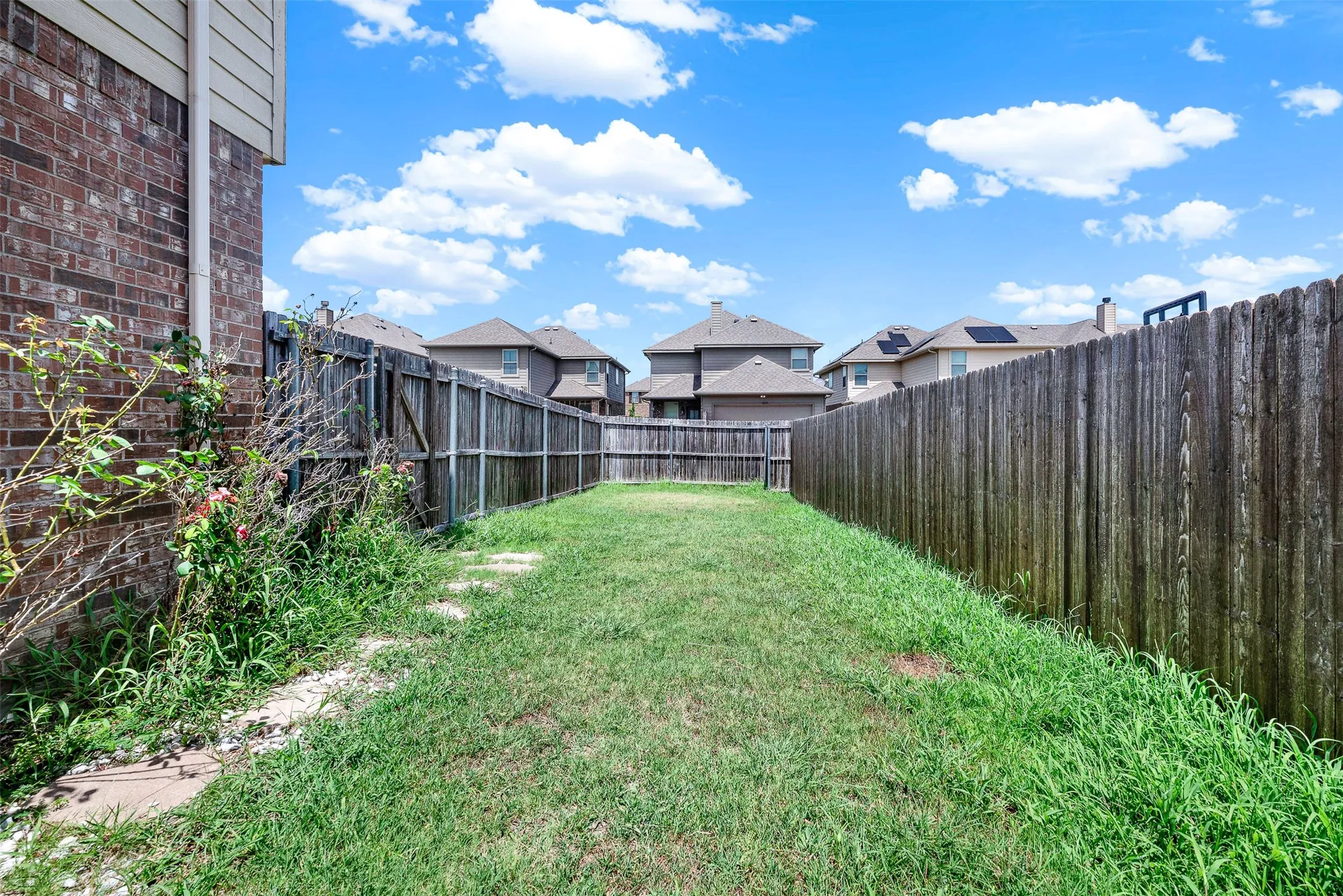 Grassed backyard with wood privacy fencing