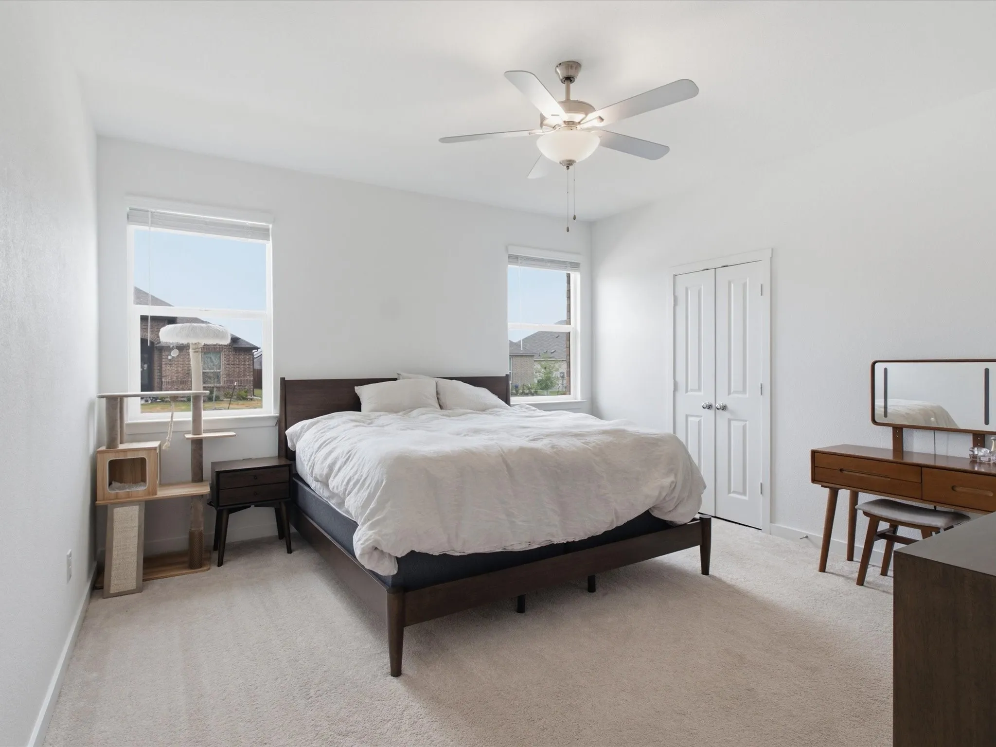 Bright room featuring light-toned carpet flooring and neutral walls