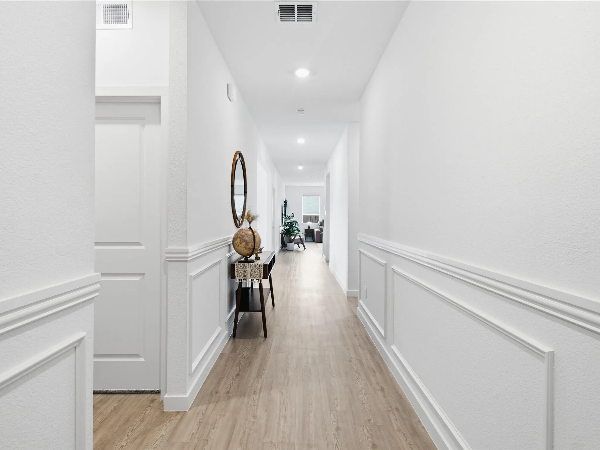 Hallway featuring extensive wainscoting, recessed lighting, wood-finish flooring, and crisp white walls