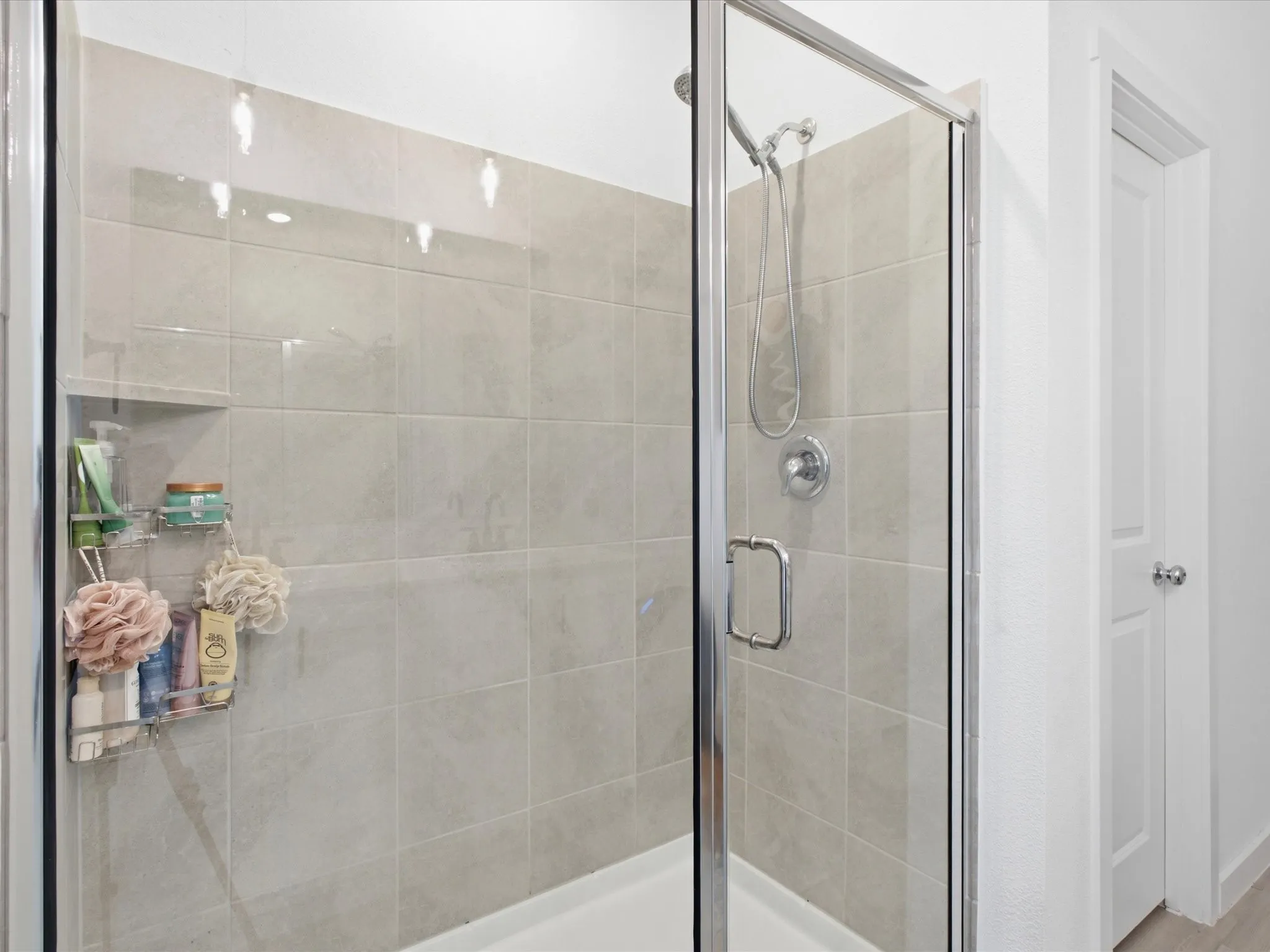 Shower enclosure featuring clear glass panels and chrome hardware