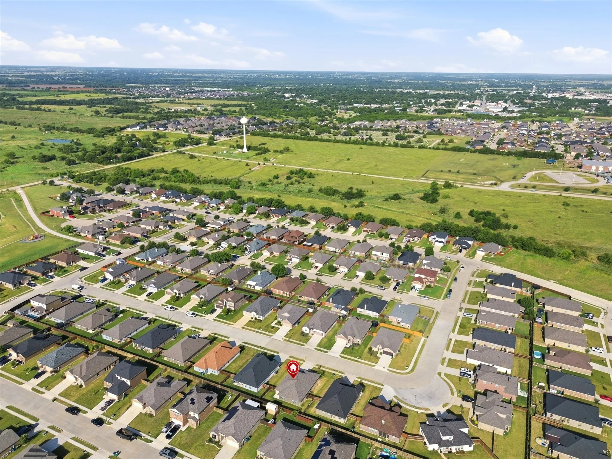 Aerial depiction of a residential subdivision featuring uniform single-story homes with varied roof colors
