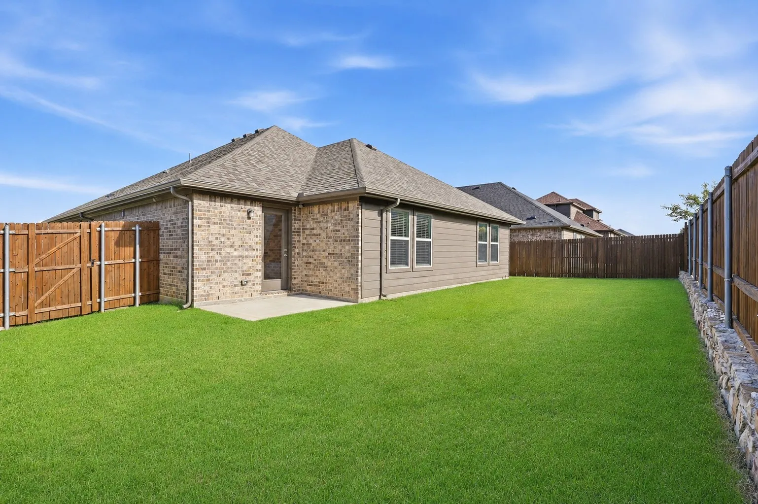Expansive backyard featuring a manicured lawn