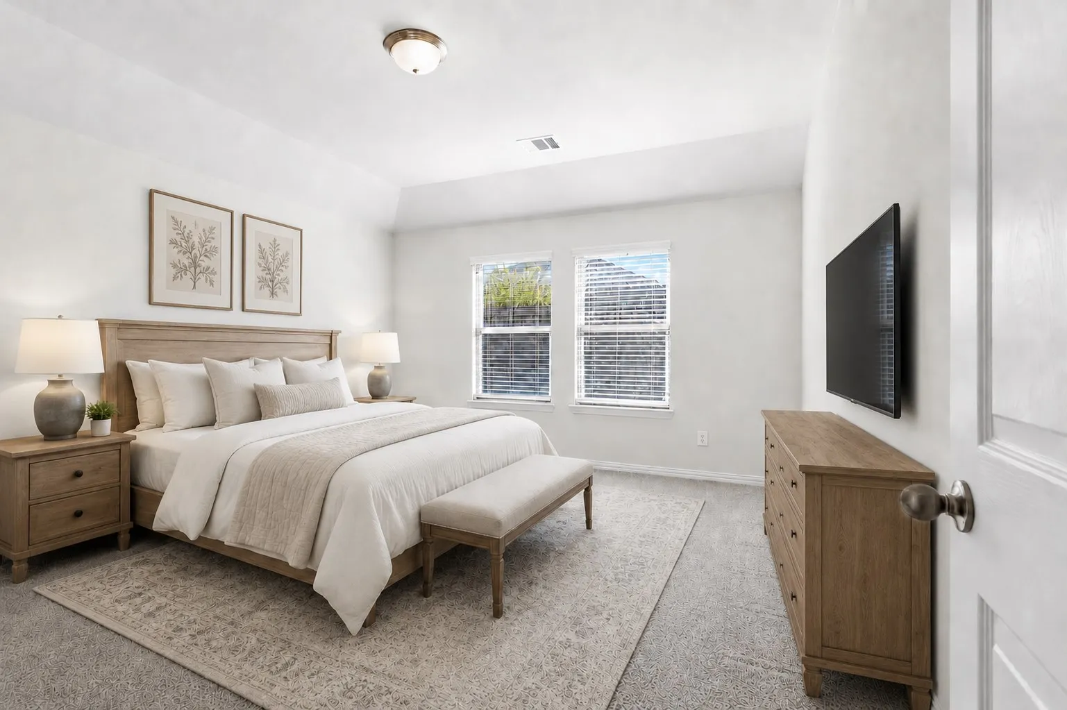 Spacious room with plush carpeting, neutral wall colors, two windows with blinds, and a tray ceiling featuring a flush-mount light fixture