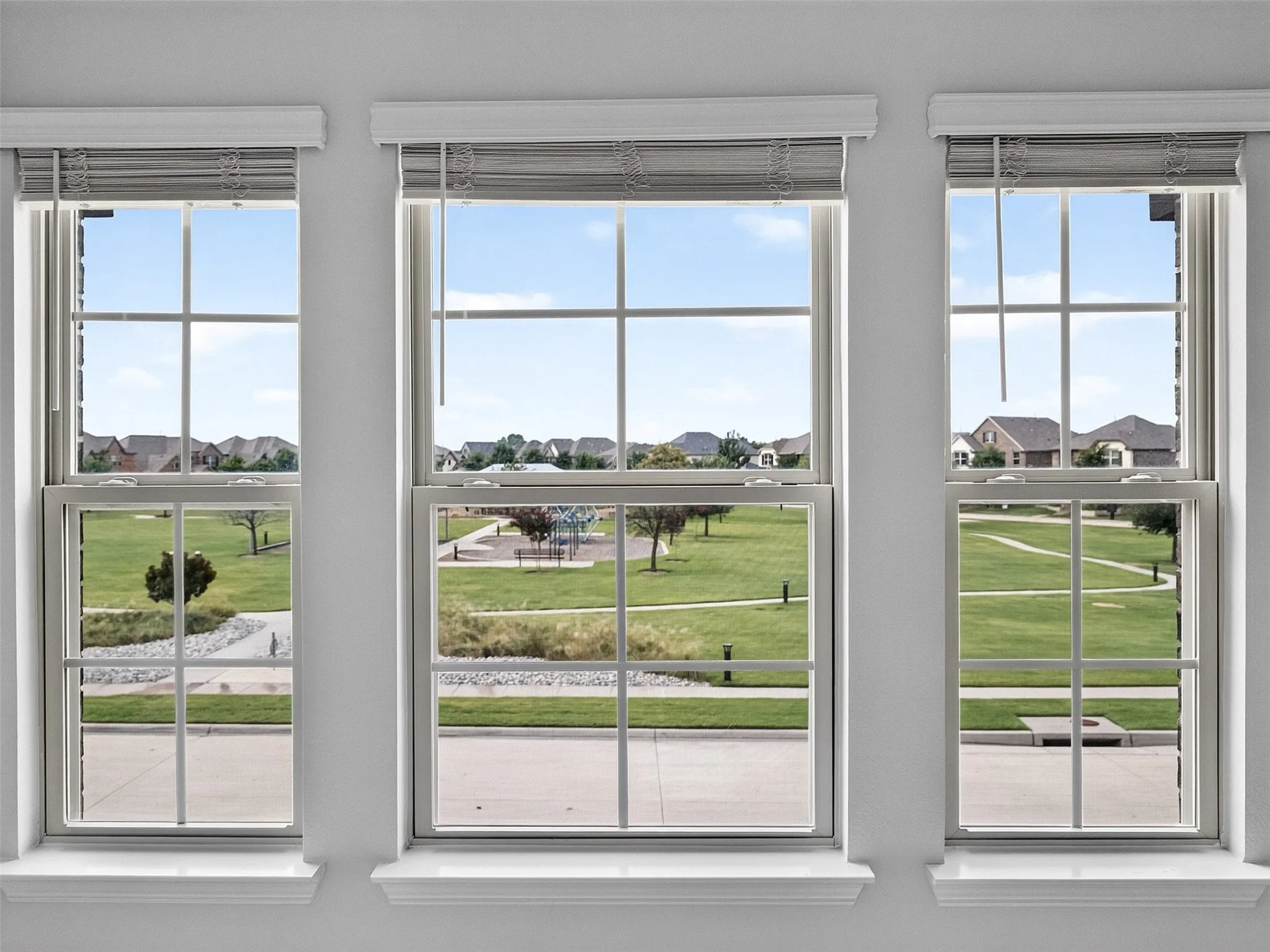 Park view from the upstairs bedroom offers a clear, scenic look over the neighborhood green space