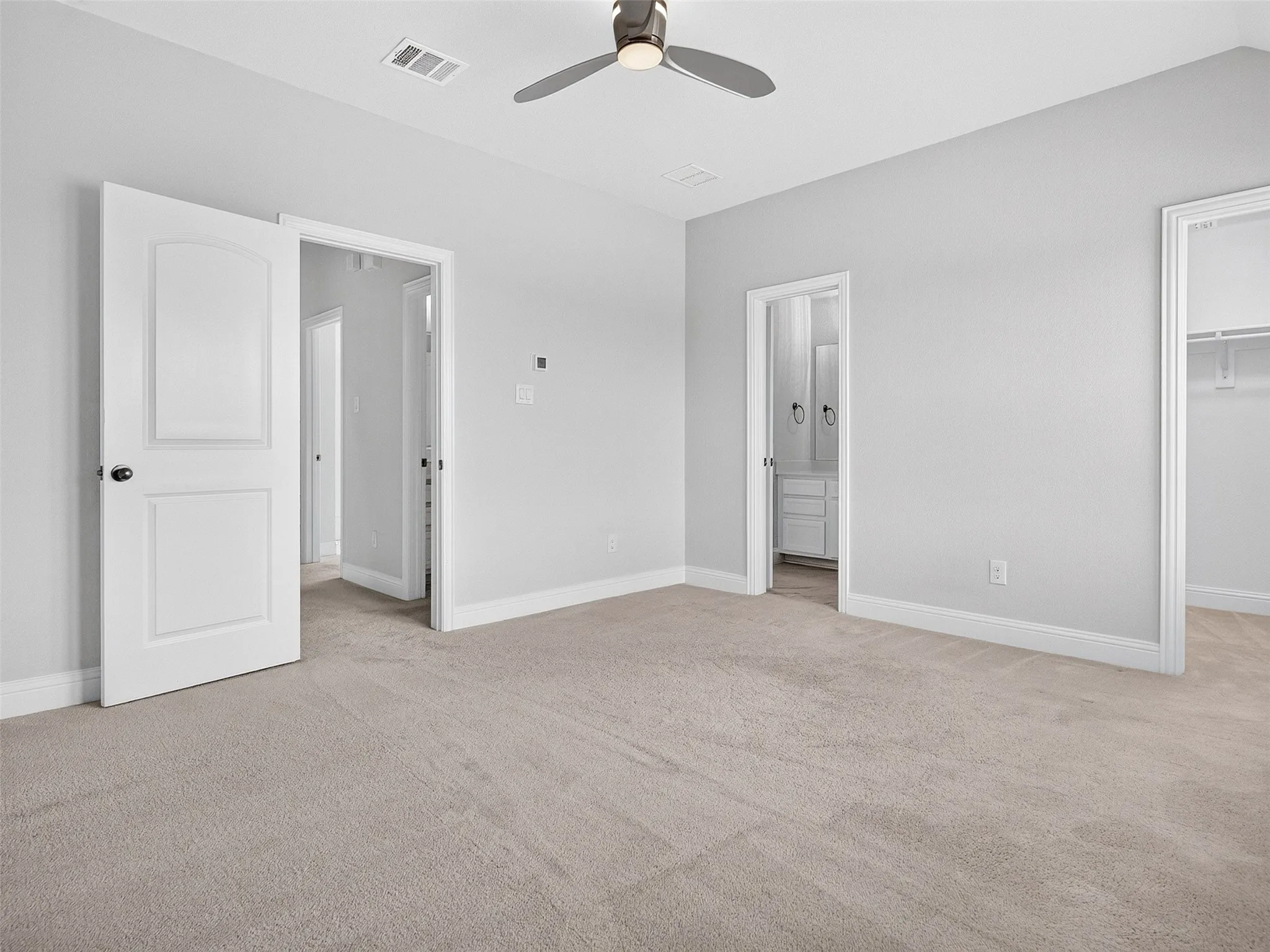 BEDROOM 4: Neutral-toned carpet flooring with light gray walls and white trim