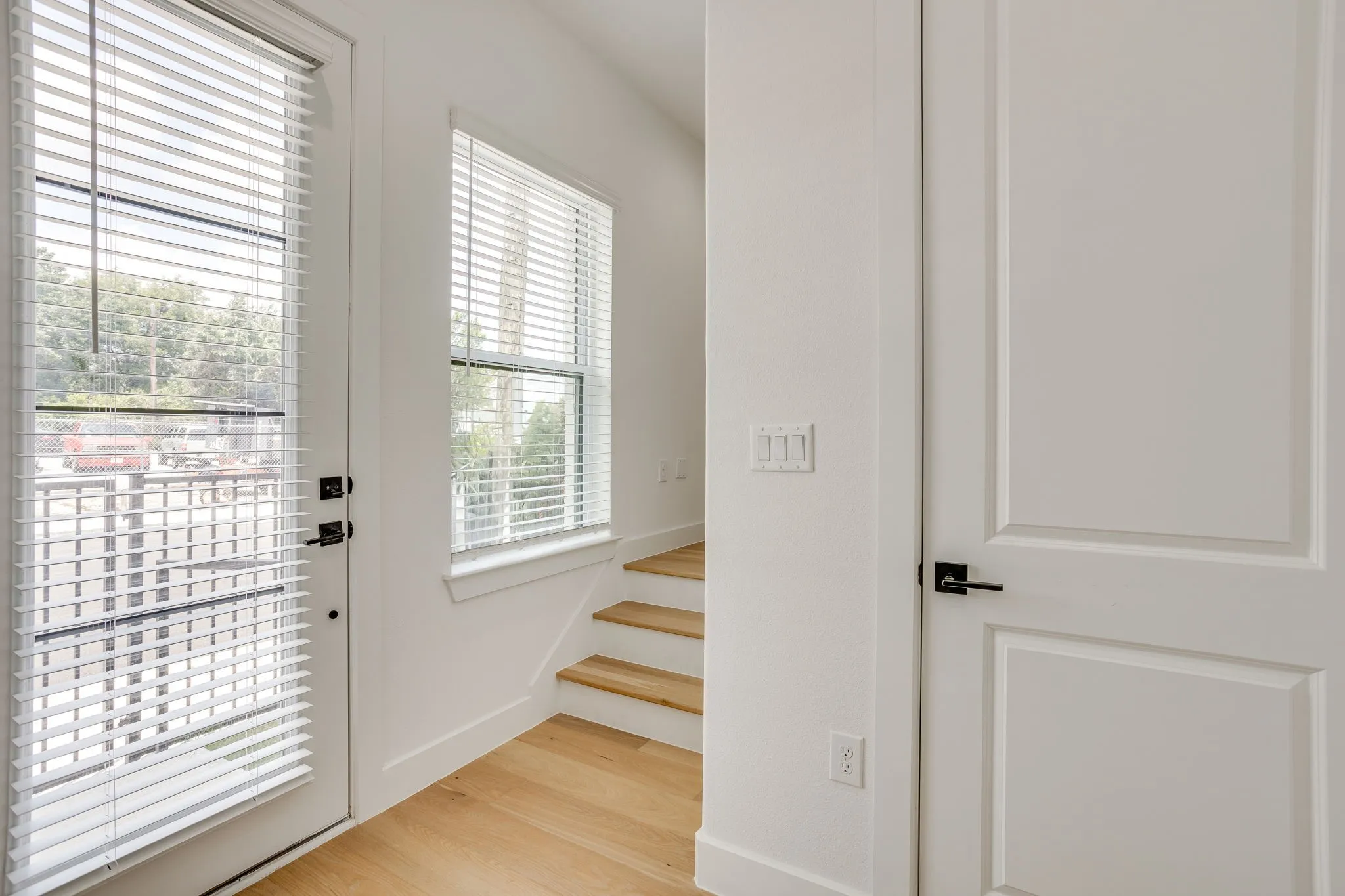 Light wood-finish flooring complements the crisp white walls