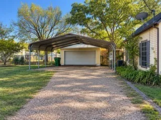 Large carport and large detached garage with metal roof