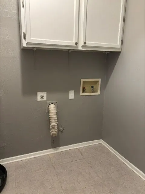 Full size washer and dryer with cabinets overhead