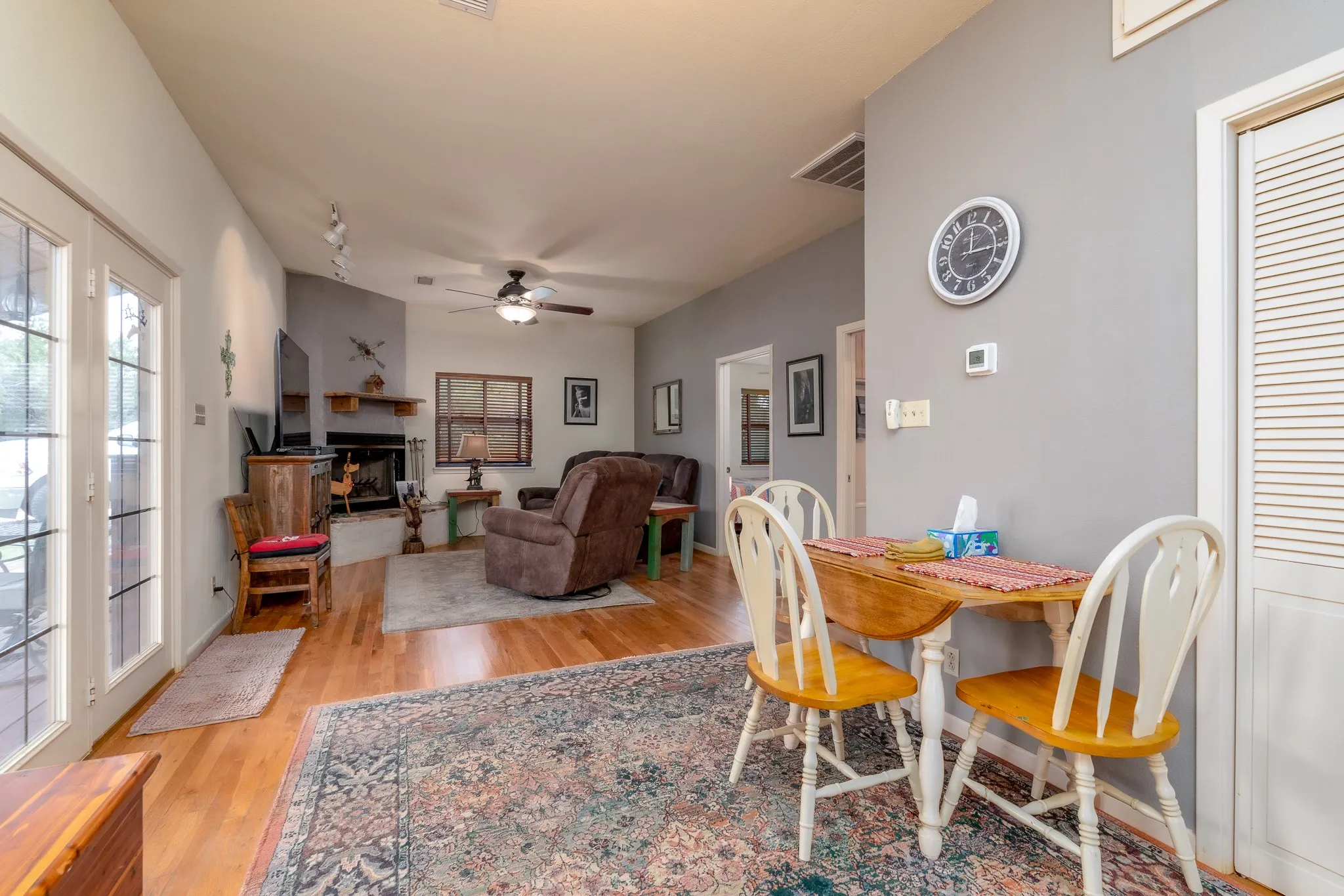 Open-concept living space with wood-finish flooring