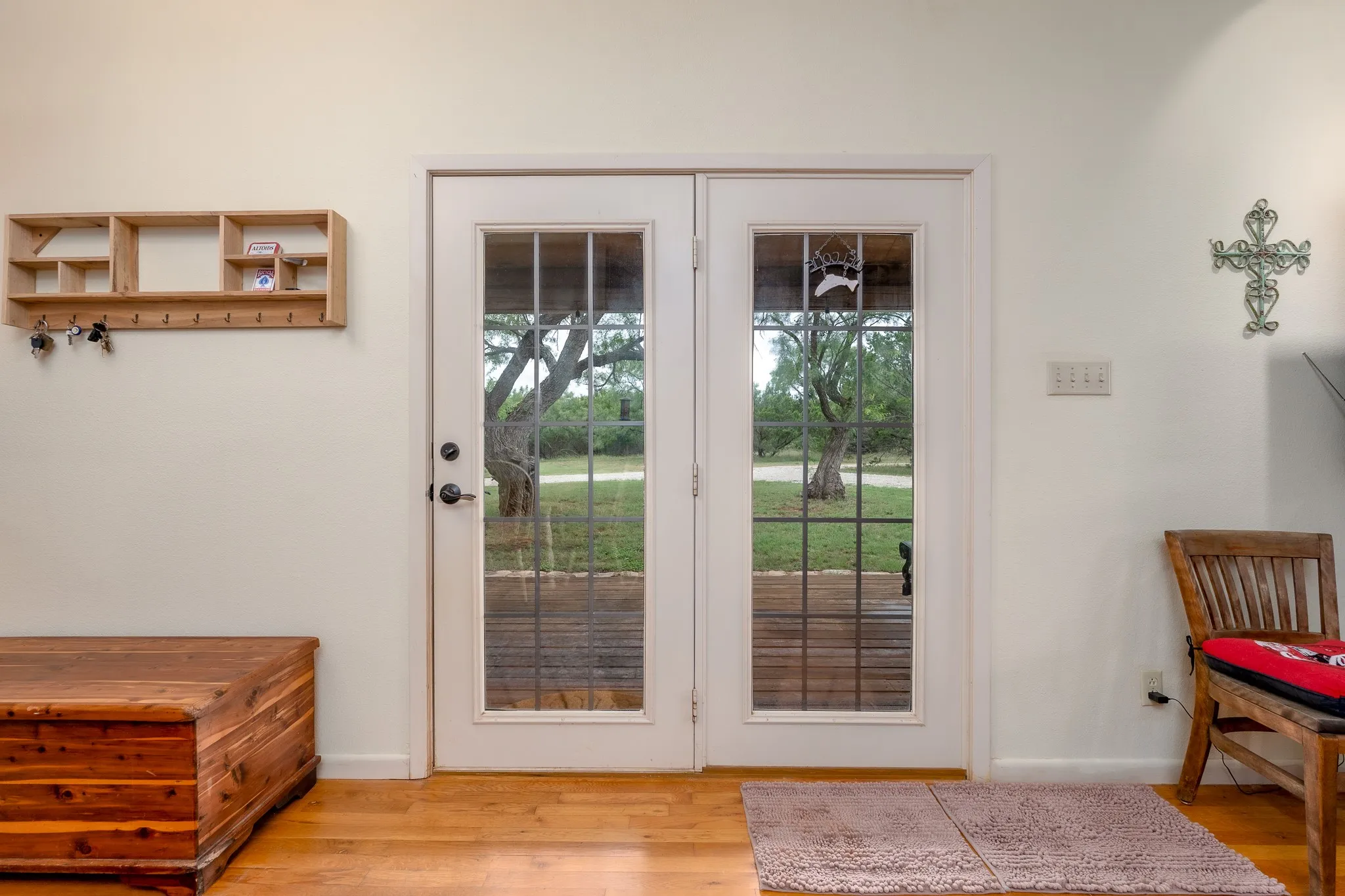 Double French doors with divided lites, polished hardware, and exterior views