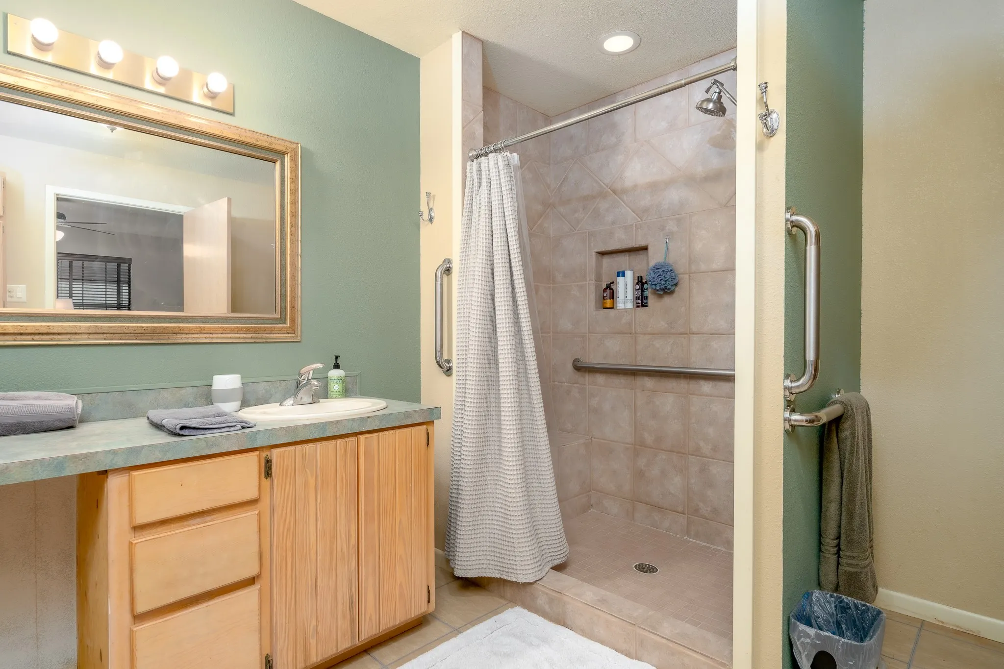 Bathroom vanity featuring a single basin sink, wood cabinetry, and an overhead vanity light fixture