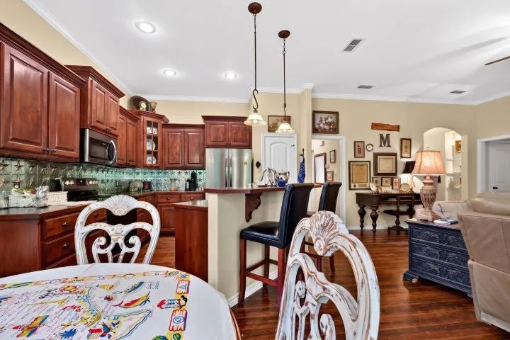 Kitchen featuring wood cabinetry, stainless steel appliances, and a breakfast bar
