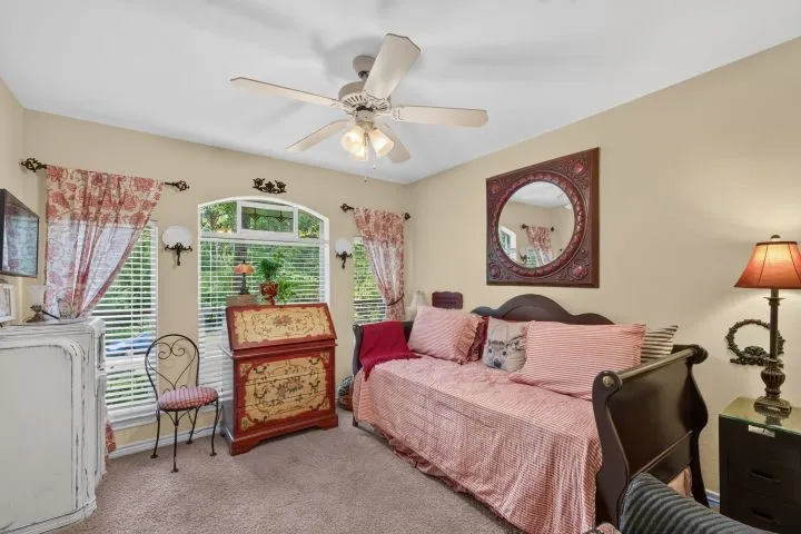Carpeted room featuring a ceiling fan with integrated lighting