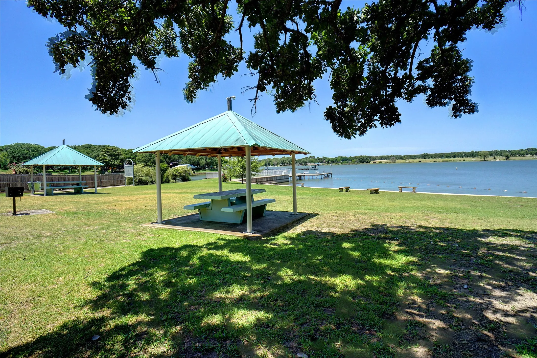 Neighborhood recreation area includes playground, picnic pavilions, swimming beach, boat launch and restroom. Gated, for residents' private use.