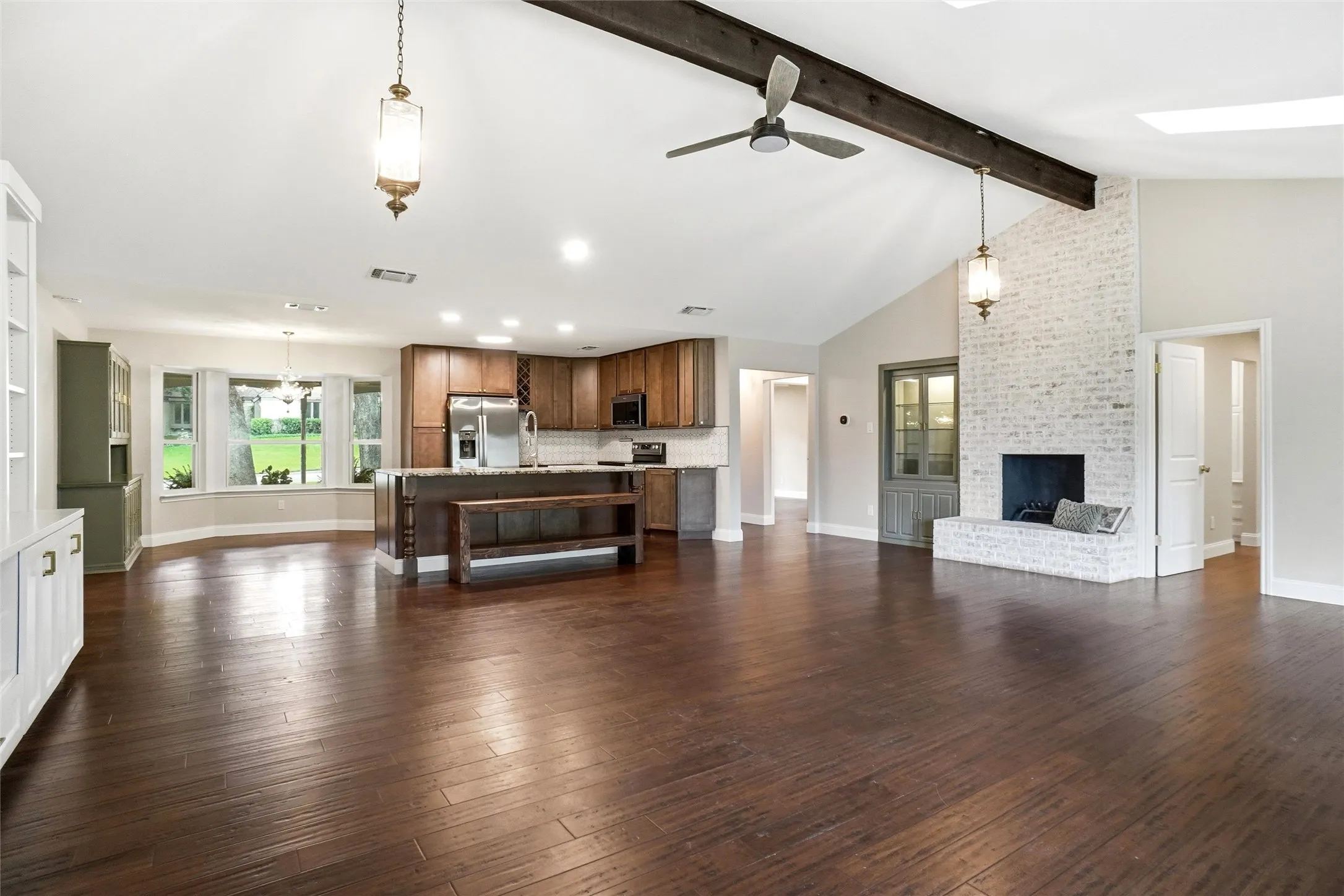 View of the kitchen and breakfast area. Beautiful natural wood cabinetry, along with more built in cabinets. Foyer and one bedroom are through the doorway furthest, and another bedroom through the near right door.
