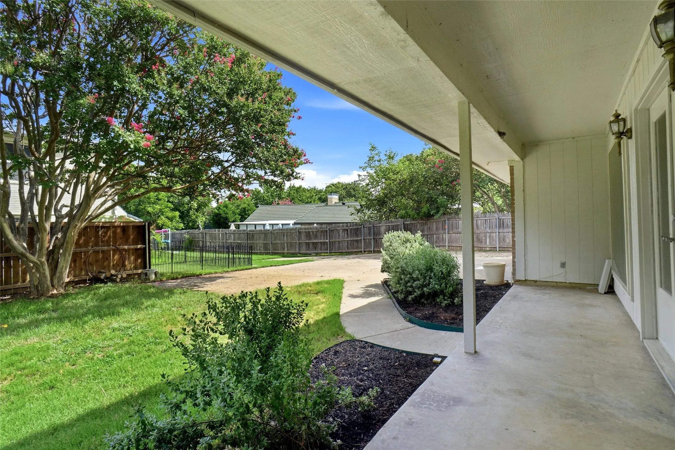 Back porch, walkway leads to rear entry garage, extra parking, and boat dock.