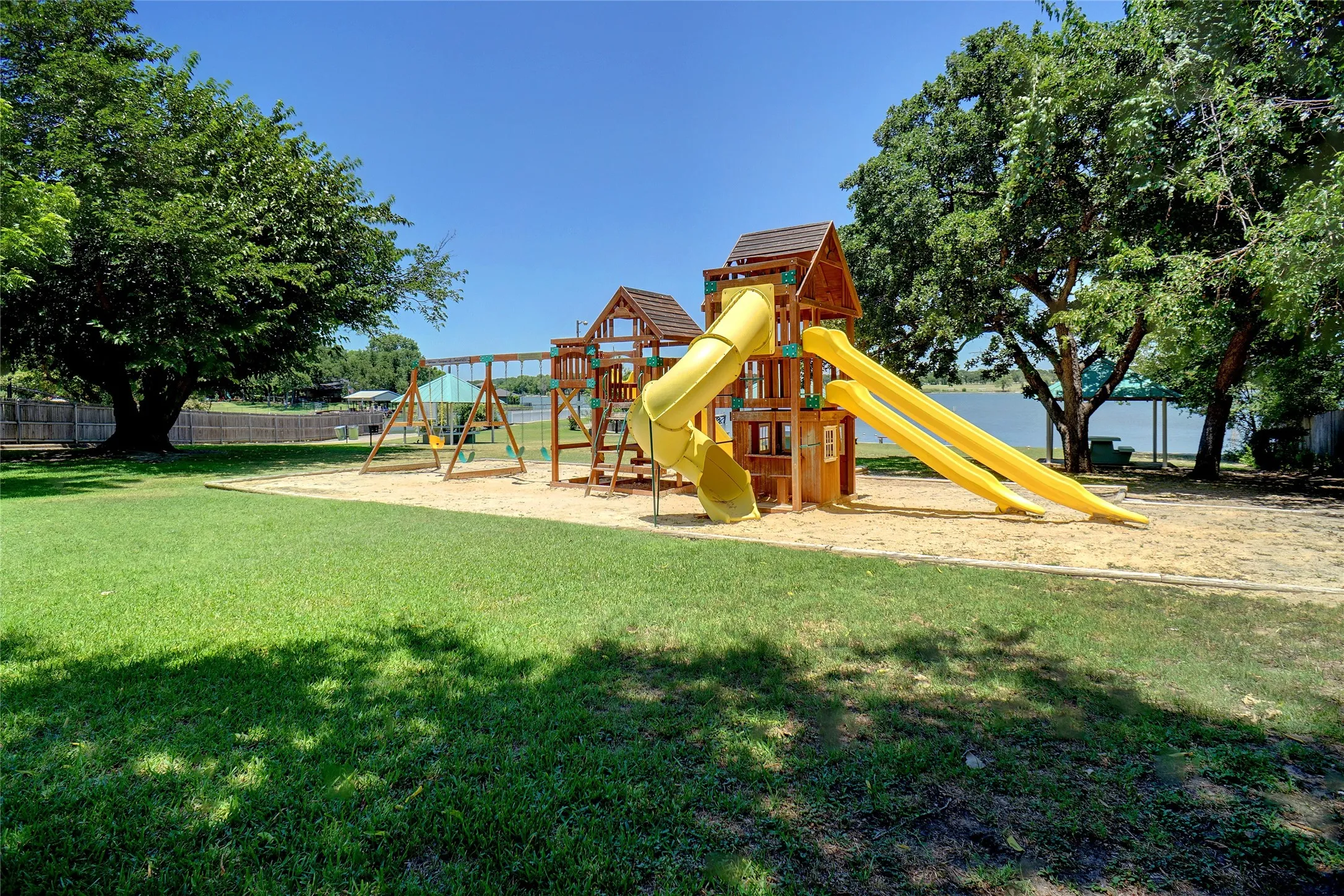Neighborhood recreation area includes playground, picnic pavilions, swimming beach, boat launch and restroom. Gated, for residents' private use.