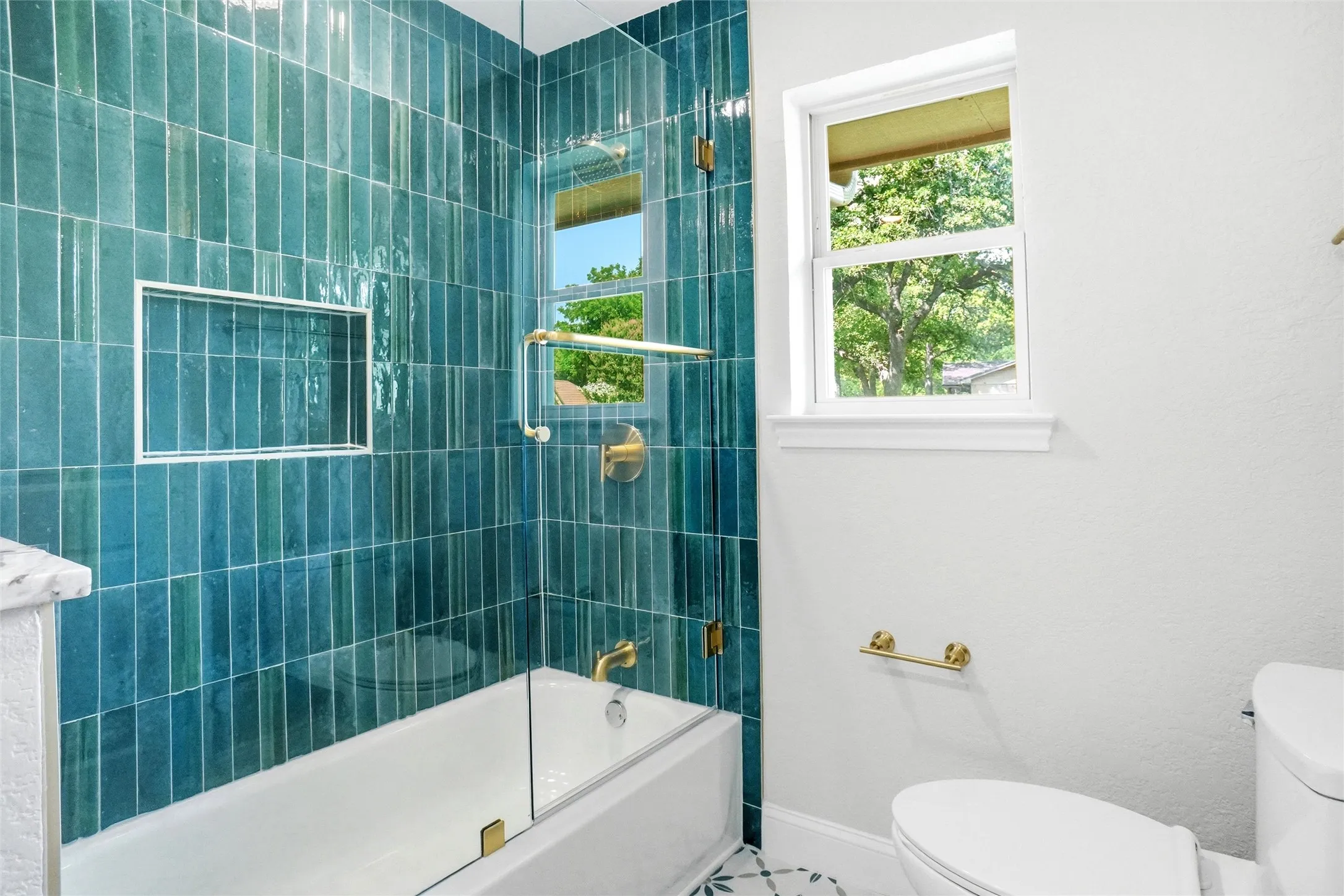Secondary bathroom with tub and shower. Look at that beautiful tile!