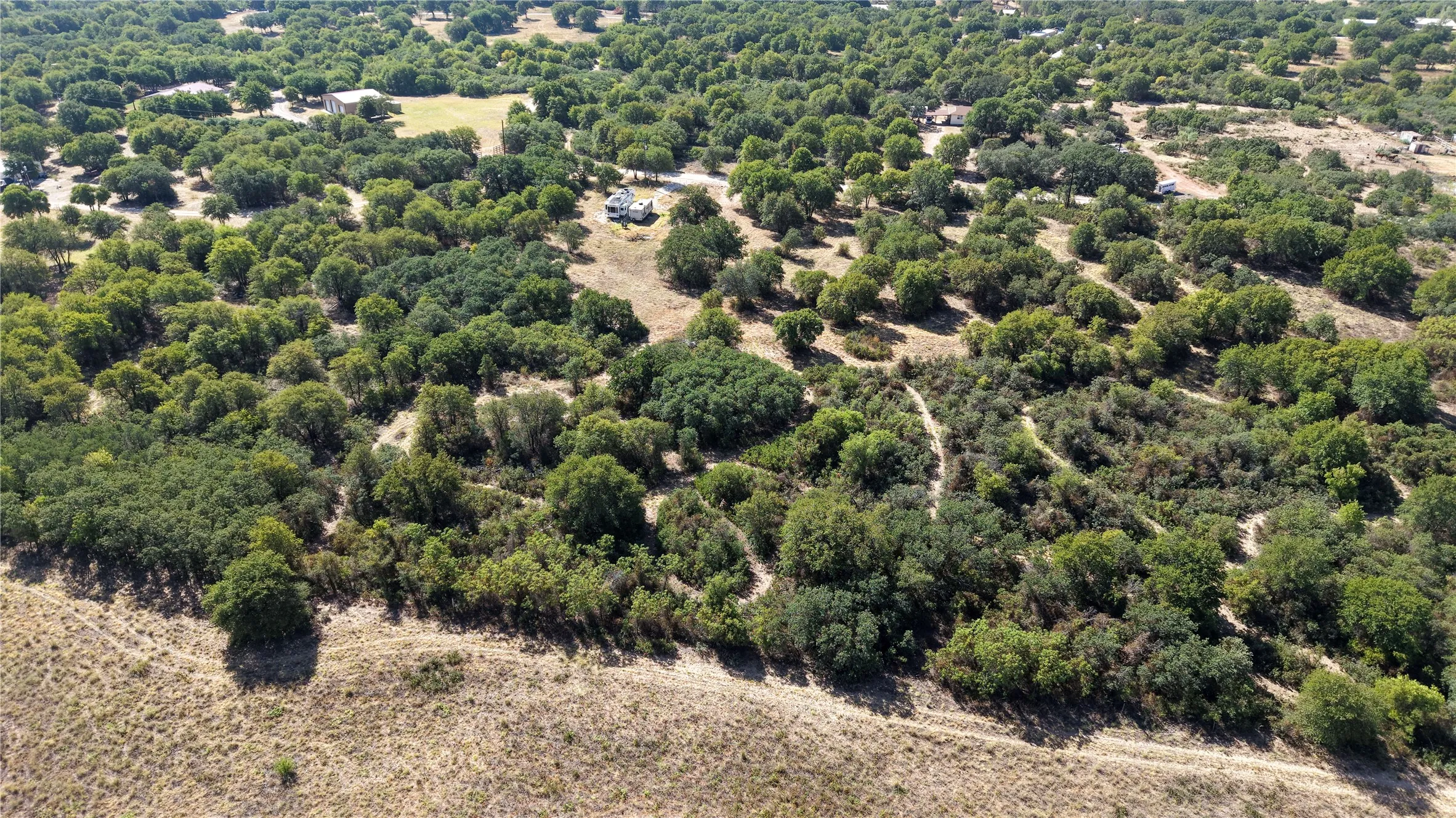 Expansive acreage featuring abundant mature trees and natural topography