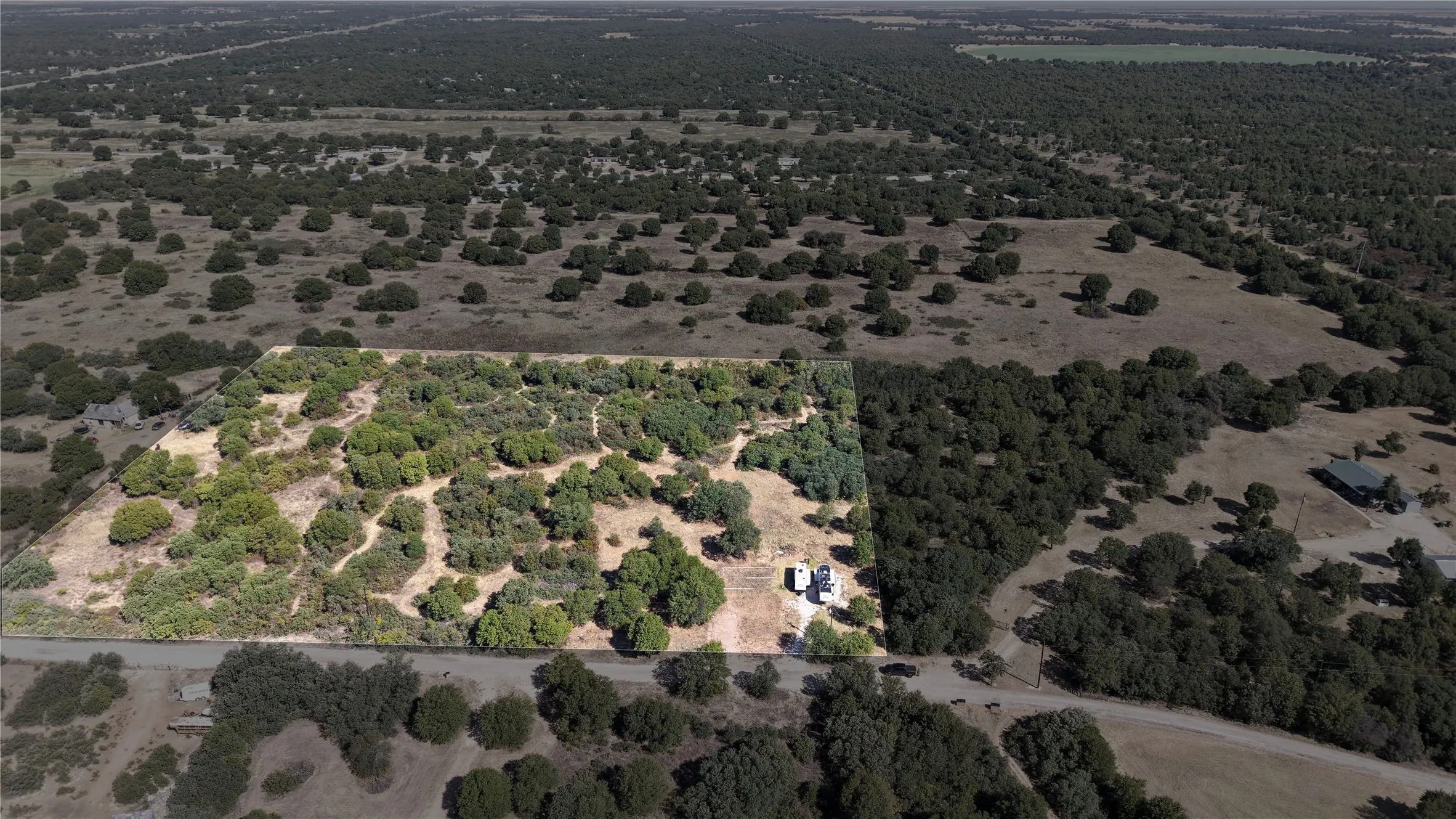 Wooded parcel with diverse tree coverage and surrounding natural landscape